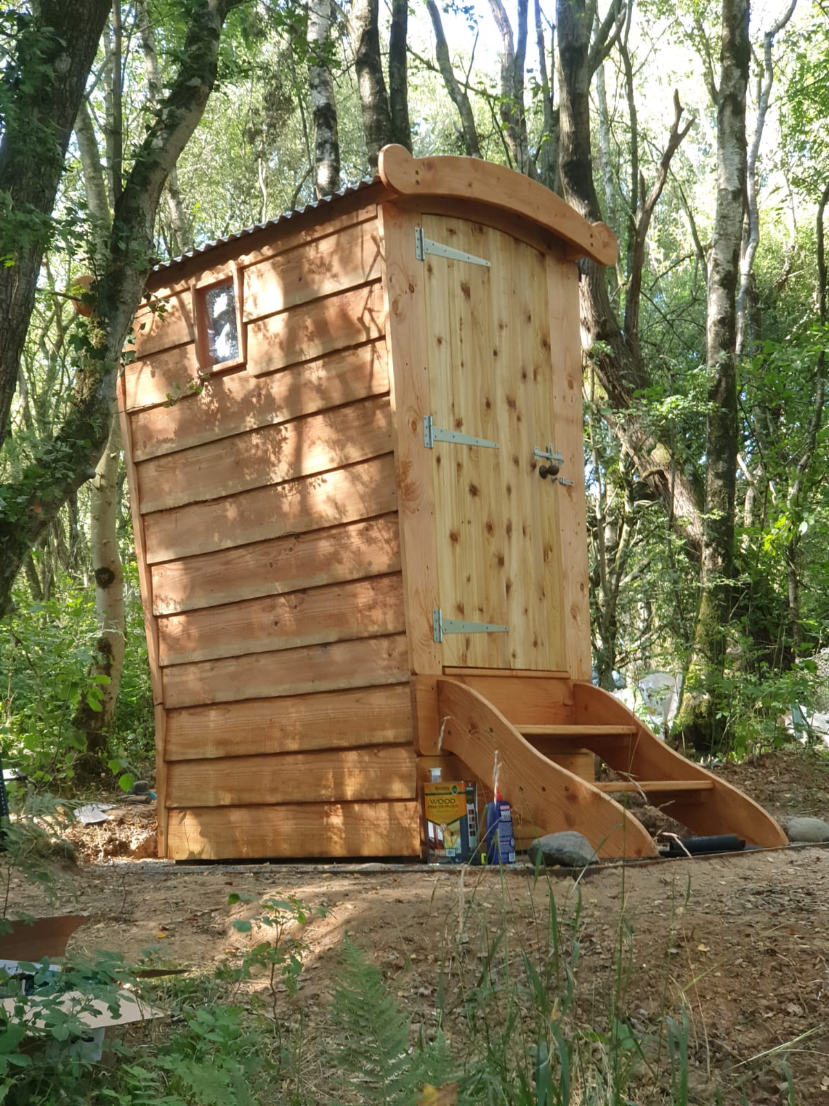 off grid toilet uk timber compost loo in woodland with curved roof