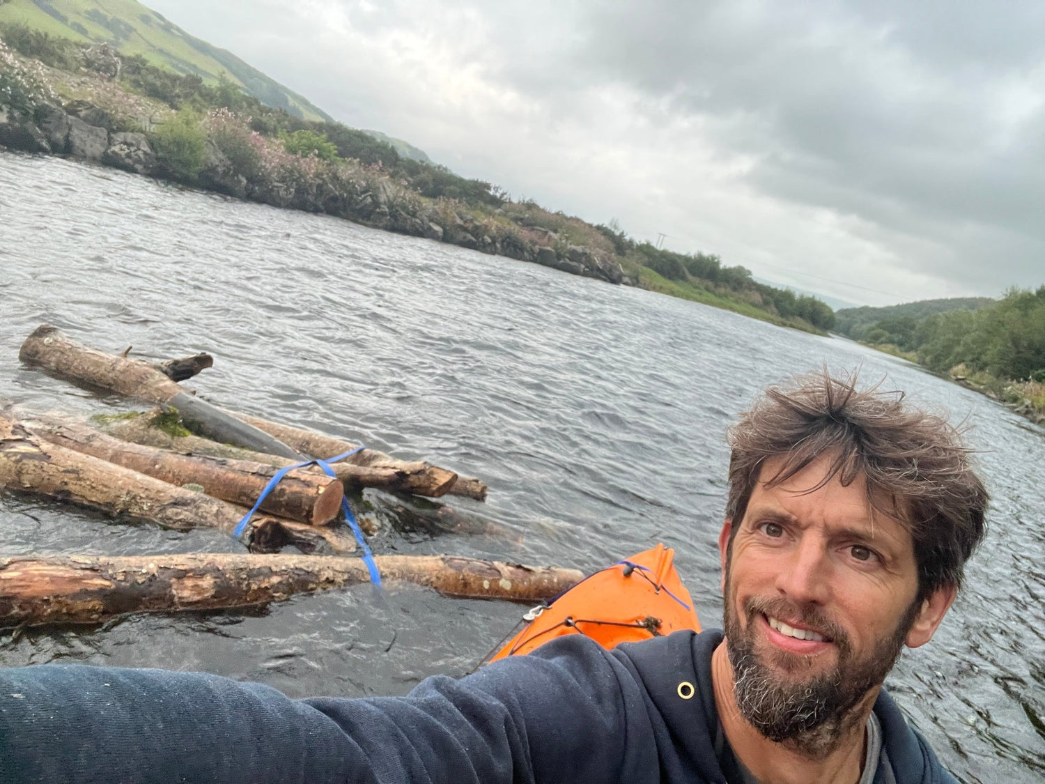 collecting driftwood in a kayak