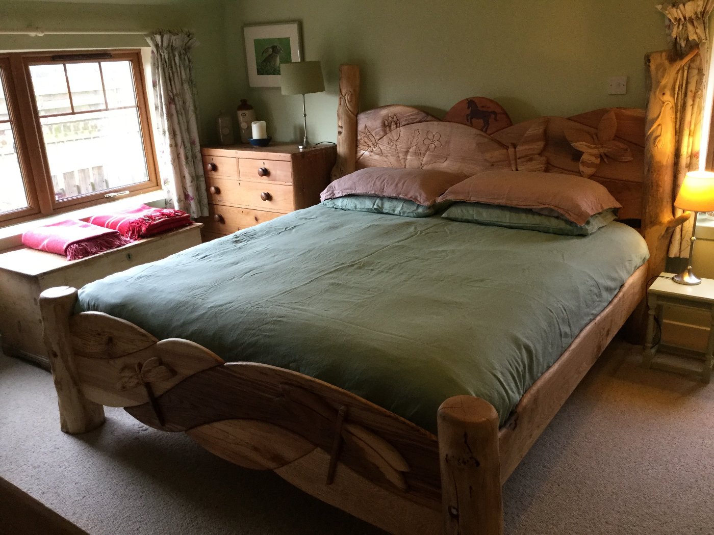 Beautiful wooden bed frame in bedroom with butterfly headboard