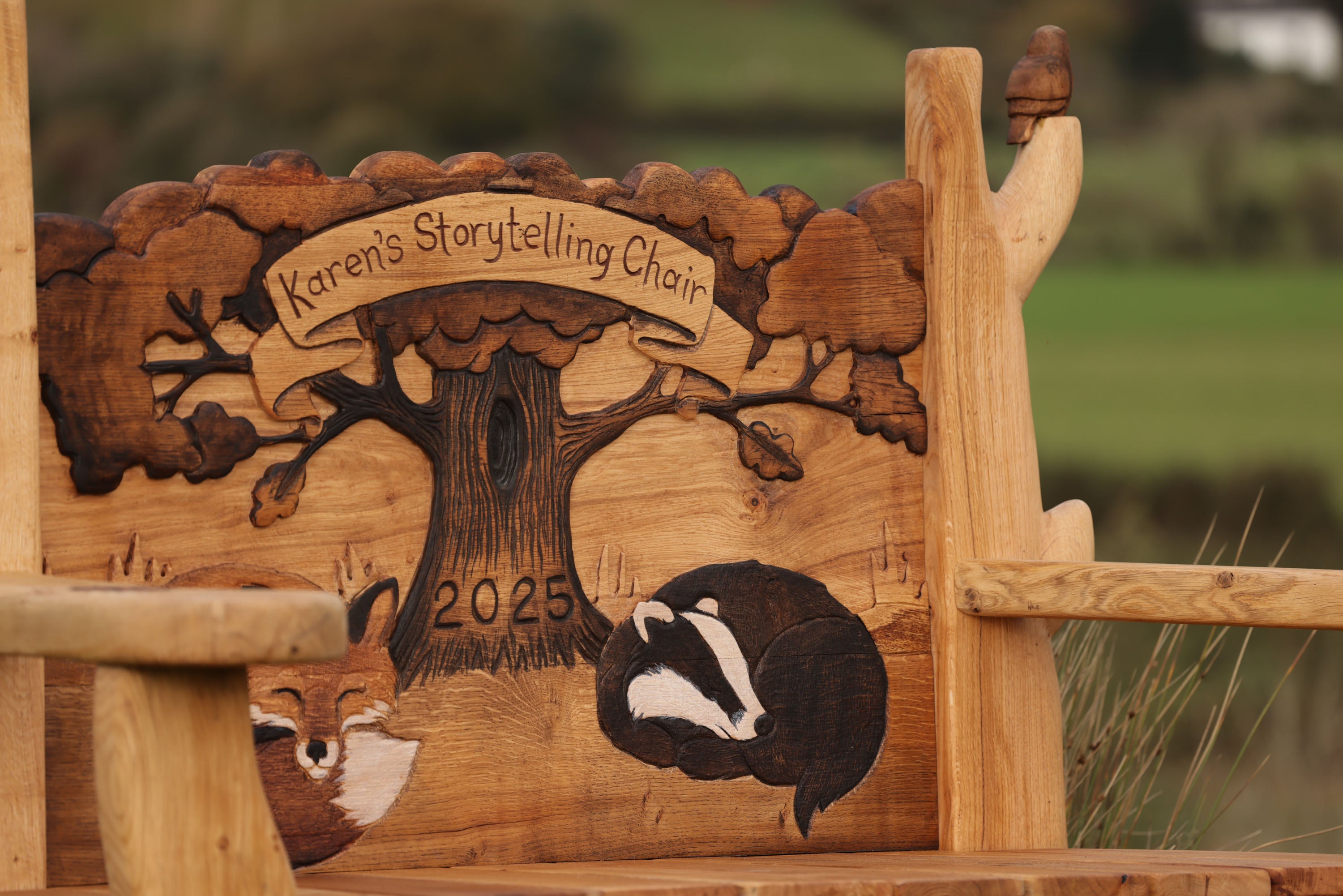 Wooden storytelling chair with engraved design and 'Karen's Storytelling Chair 2023' text.