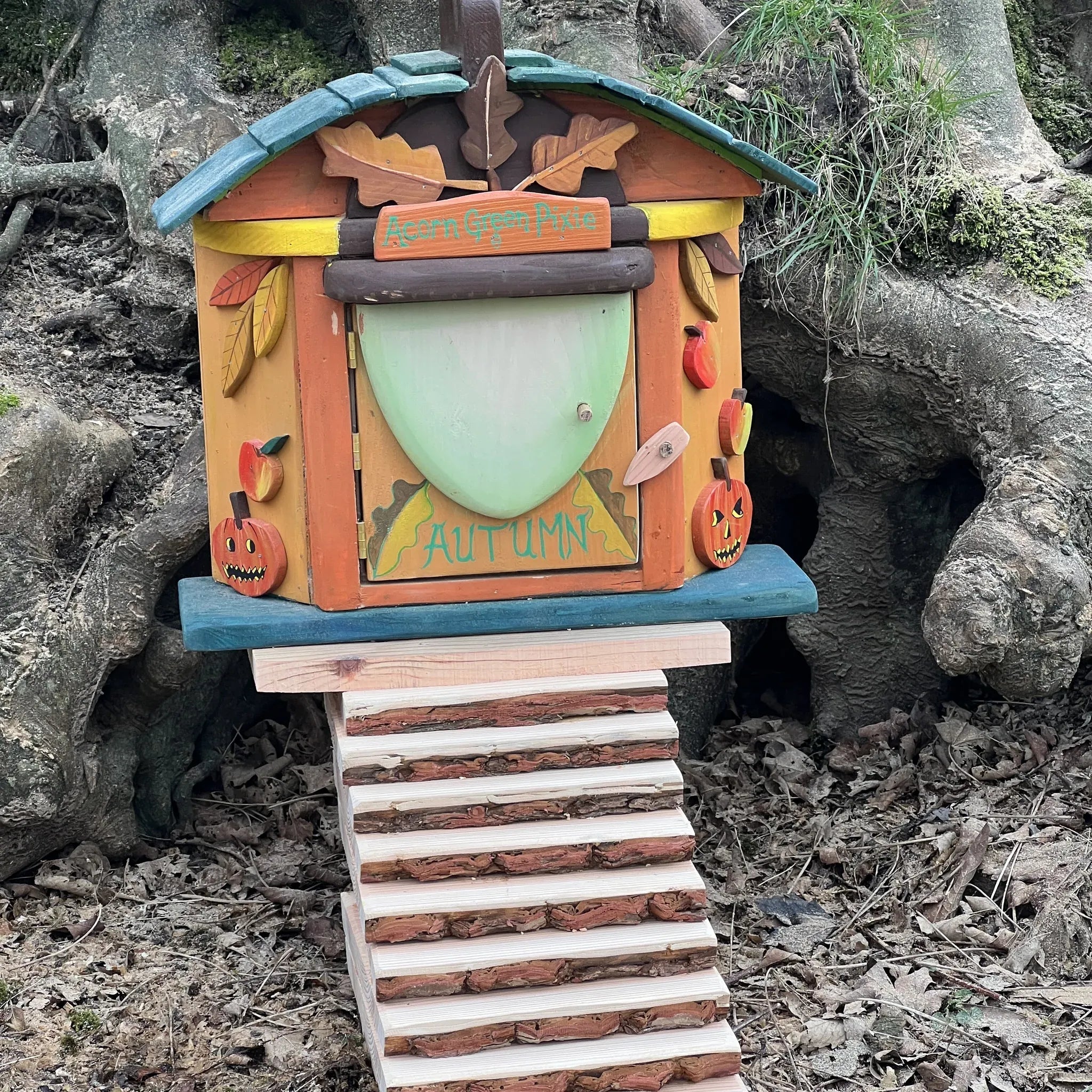 Handmade autumn acorn fairy cottage with warm harvest-season colours, acorn-cap roof and leaf painted details