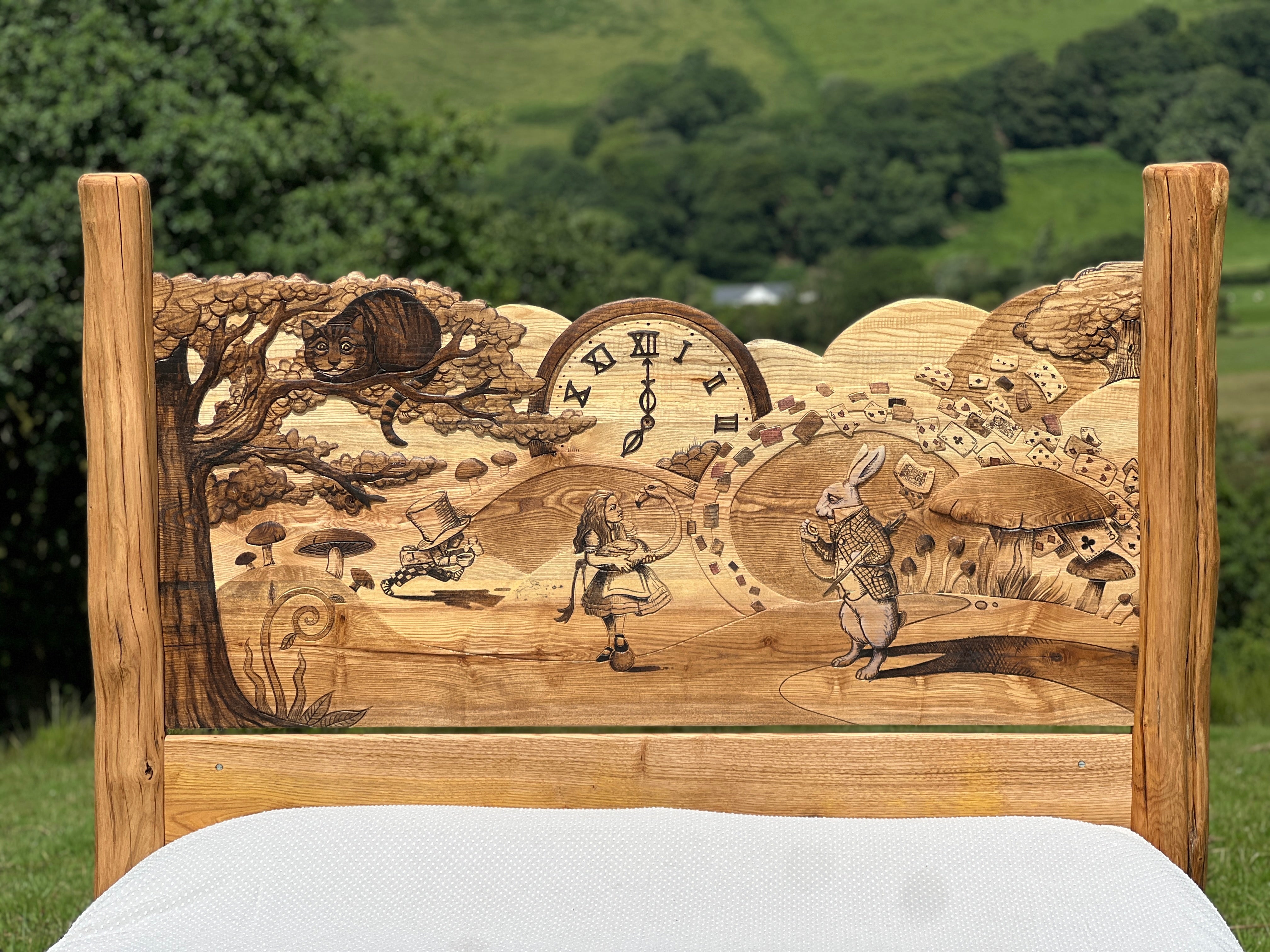 Close-up of illustrated headboard featuring White Rabbit and Alice from Wonderland