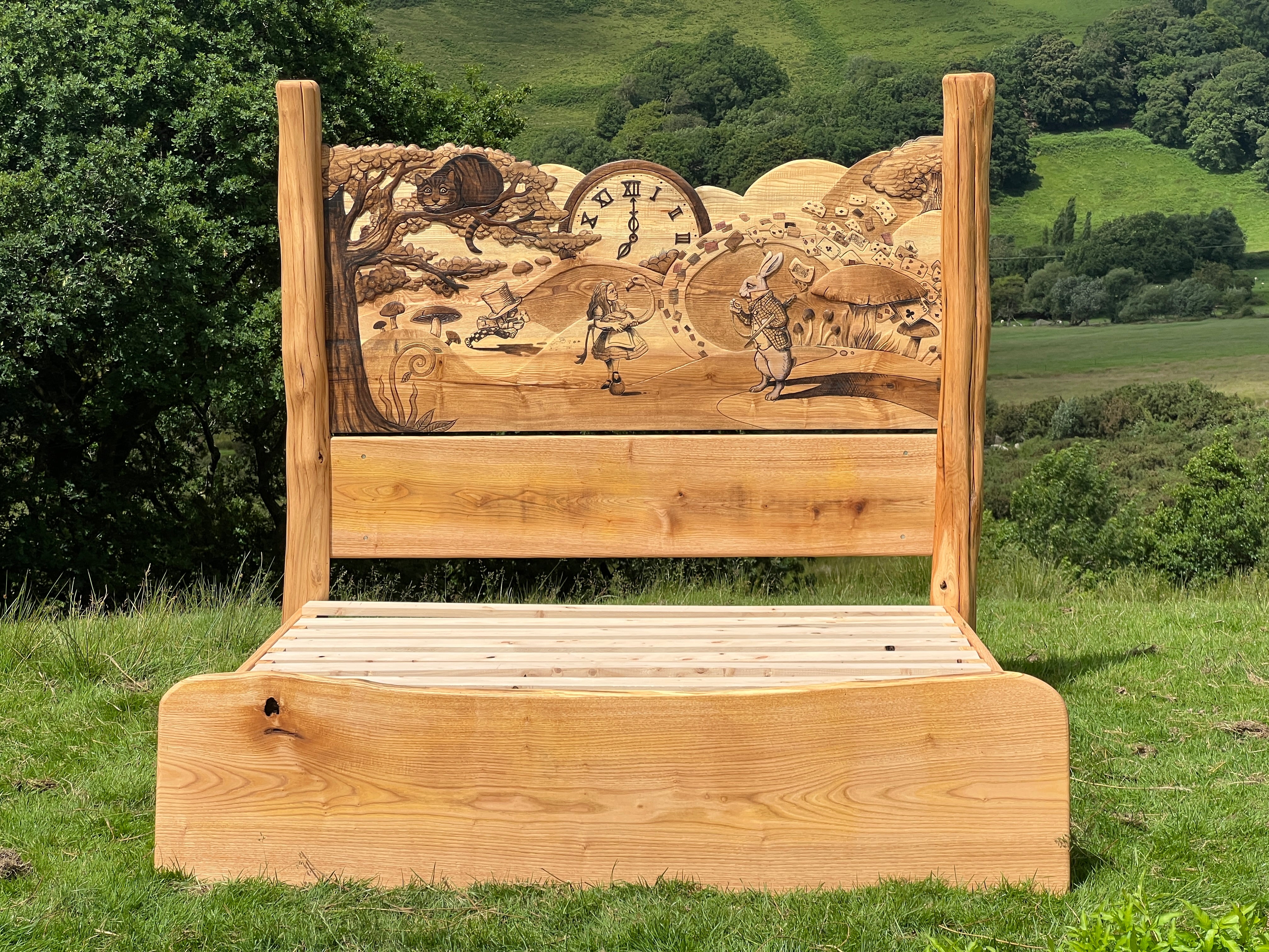 Wooden Alice in Wonderland bed frame with headboard, shown without mattress