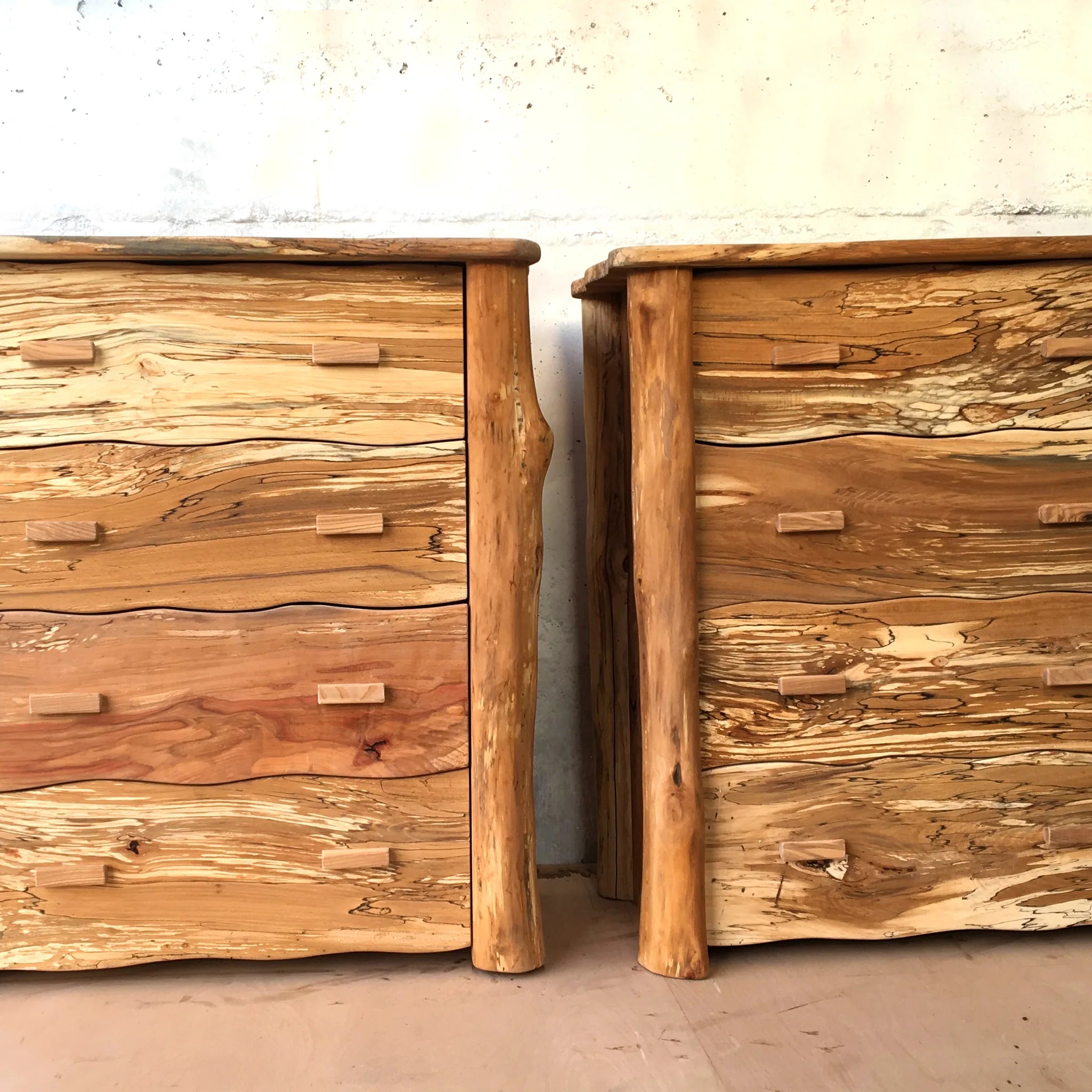 Handmade spalted beech chest of drawers with live-edge log corner posts and four sculpted wavy drawer fronts