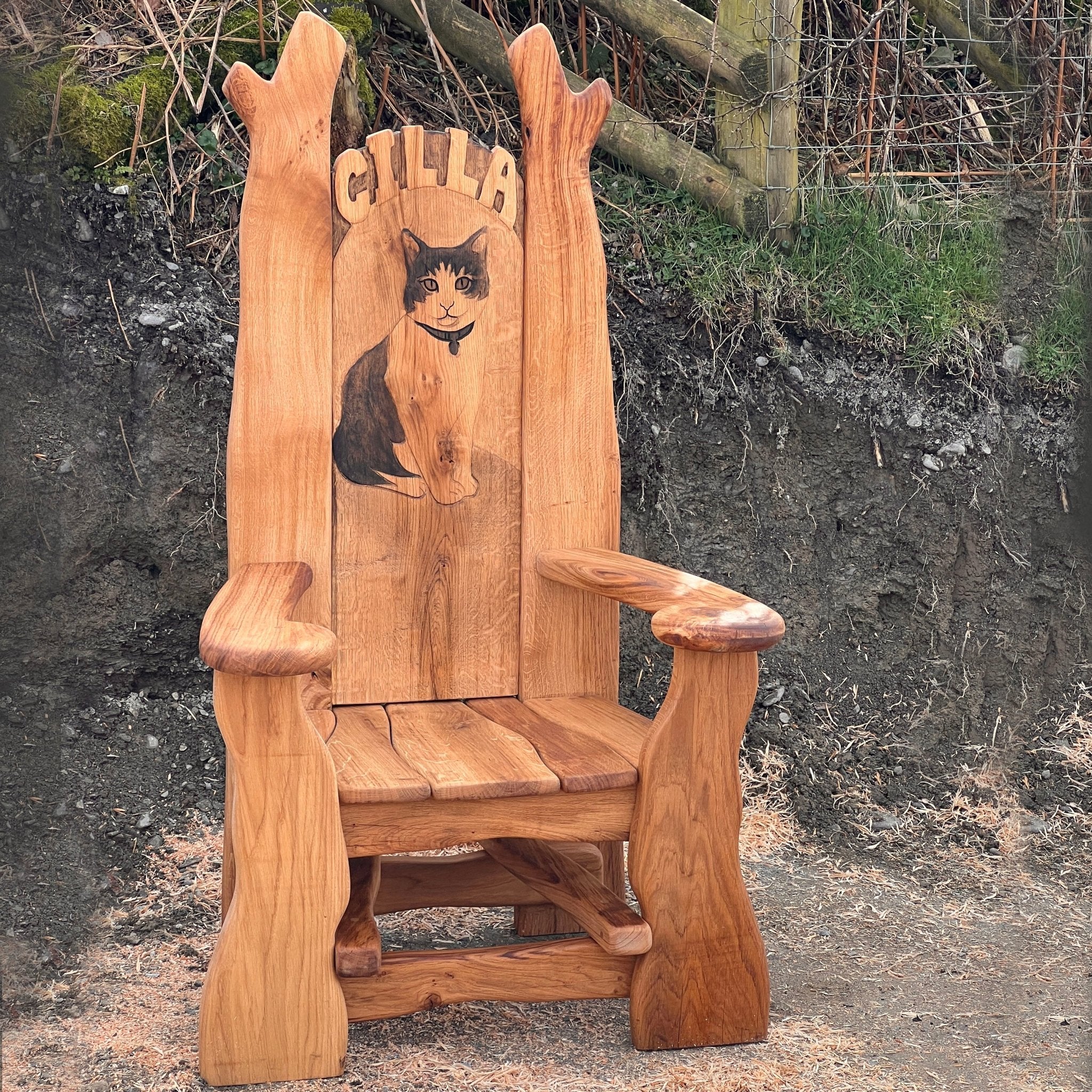 Handcrafted oak storytelling chair with engraved cat portrait in memory of Cilla