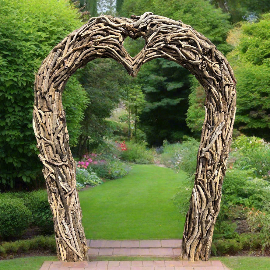 Heart-shaped arch made of natural branches in a garden setting