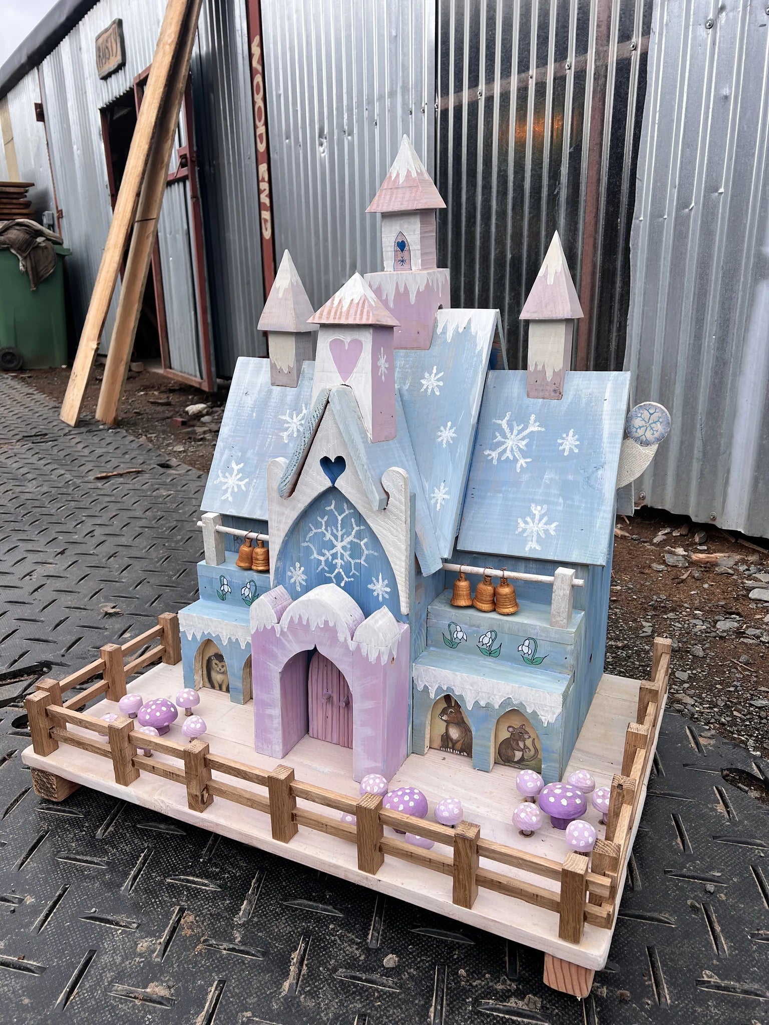 Rear view of handmade ice palace fairy house showing reclaimed timber and winter-scene painted details