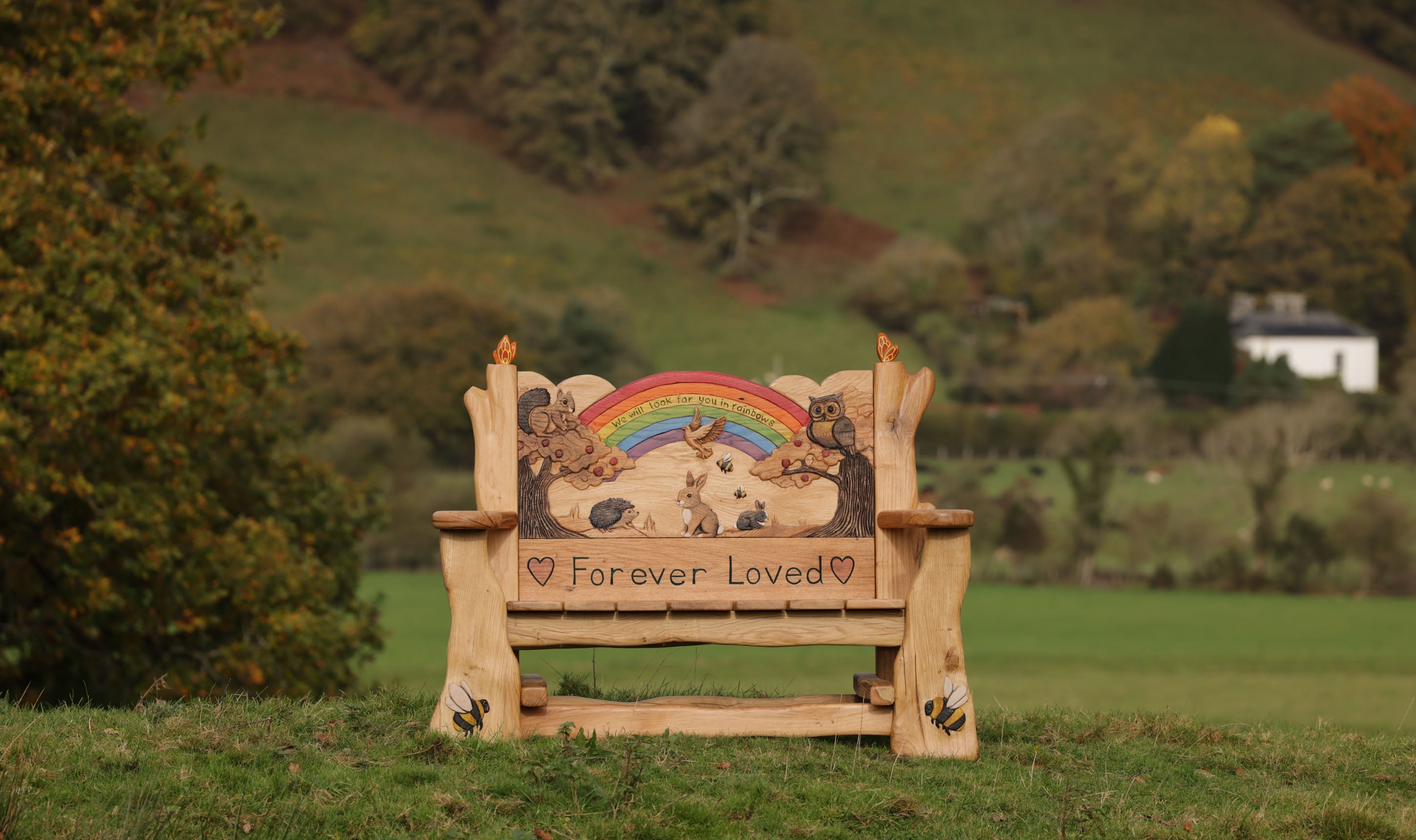 handcarved oak bench with rainbow inscription we will look for you in rainbows