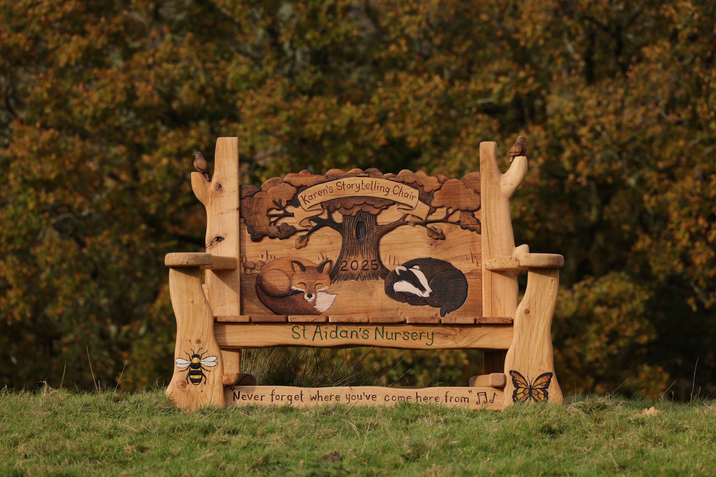 handcarved memorial storytelling chair with fox and badger carving
