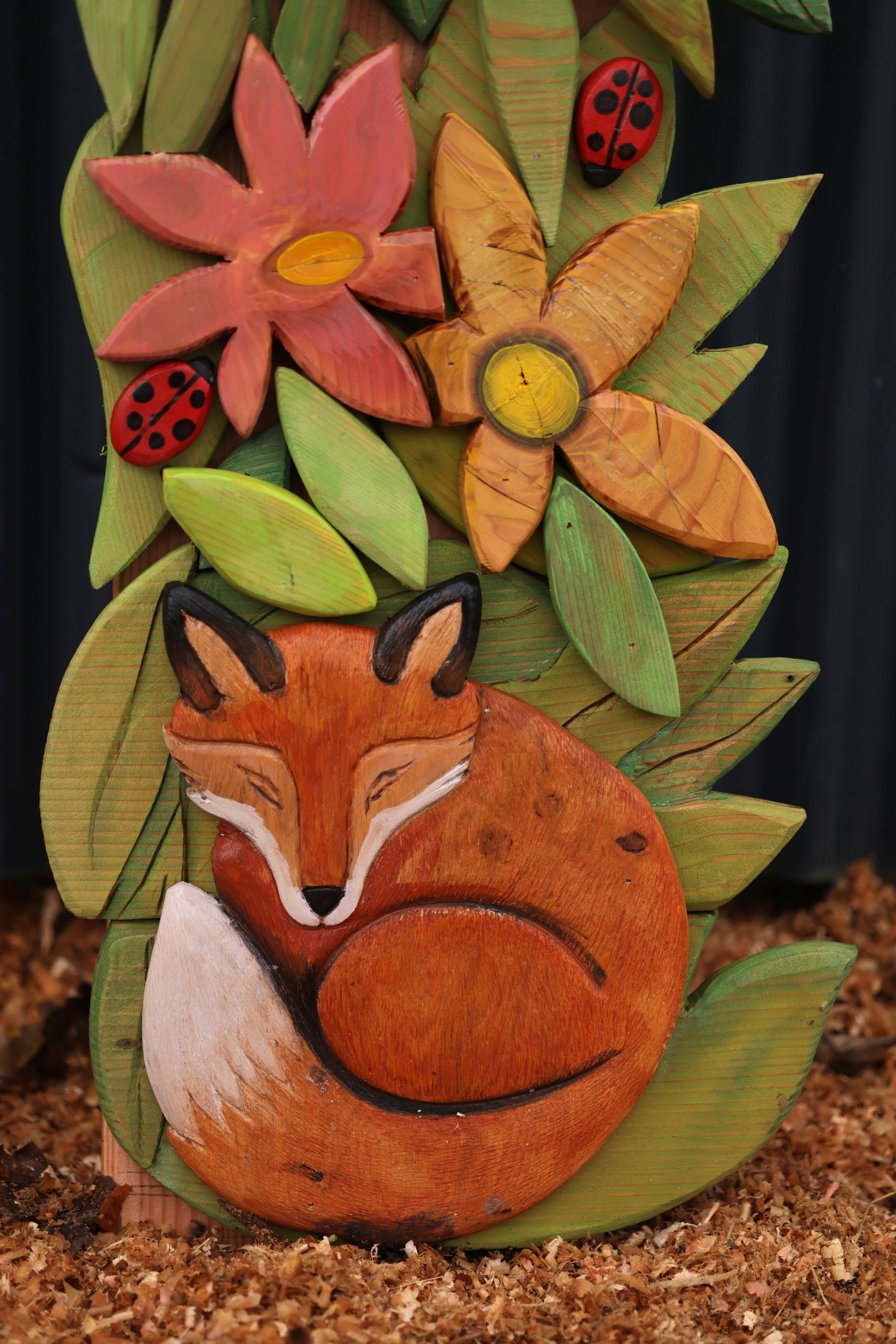 carved fox on arch with flowers