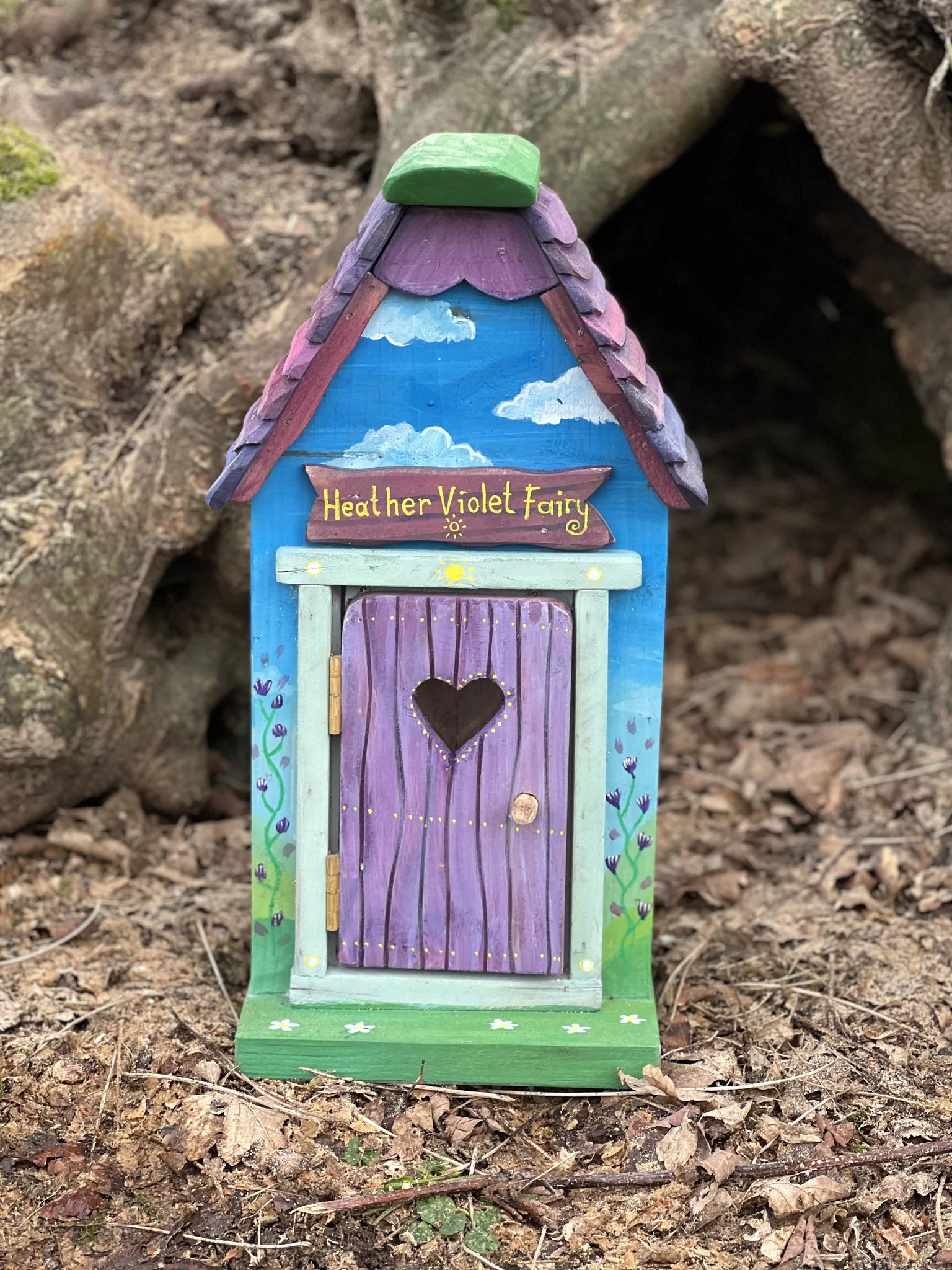Rear angle of small hexagonal fairy cottage showing natural timber grain and hand-crafted details