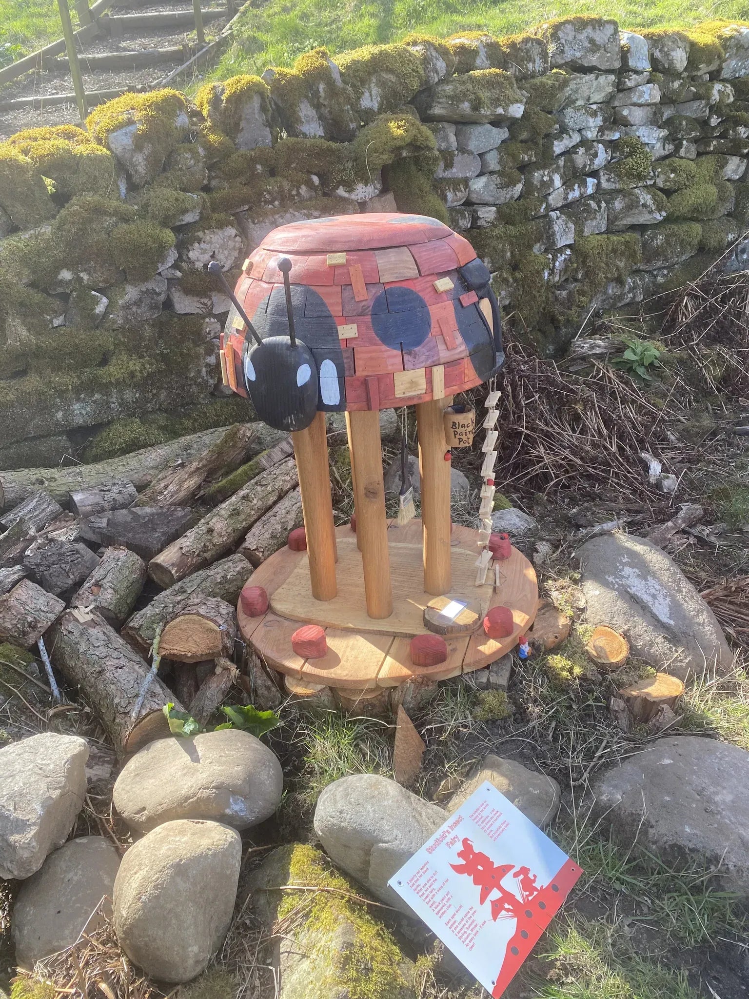 Rear view of hexagonal mushroom fairy house showing natural timber grain and hand-painted cap details