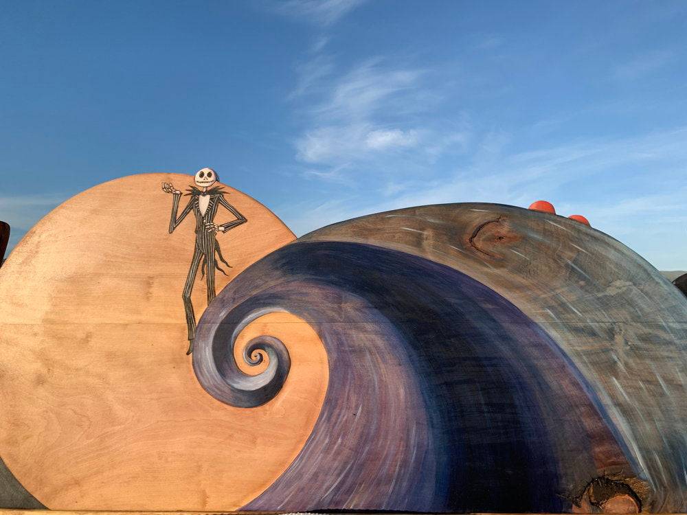 Fantasy-themed bed with detailed carvings and vibrant illustrations, perfect for Tim Burton fans.