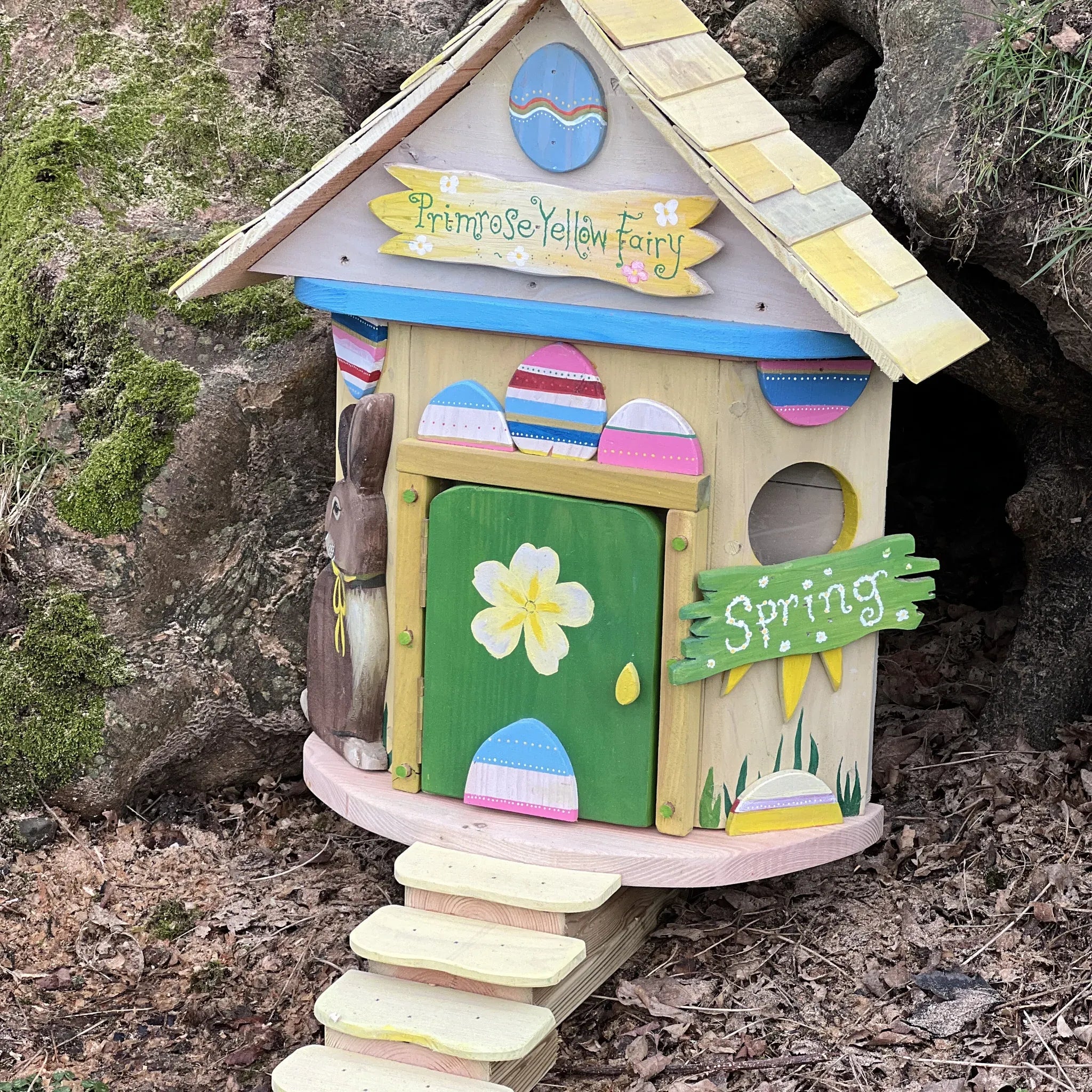 Handmade primrose yellow spring fairy cottage with soft yellow painted walls and flower garden details