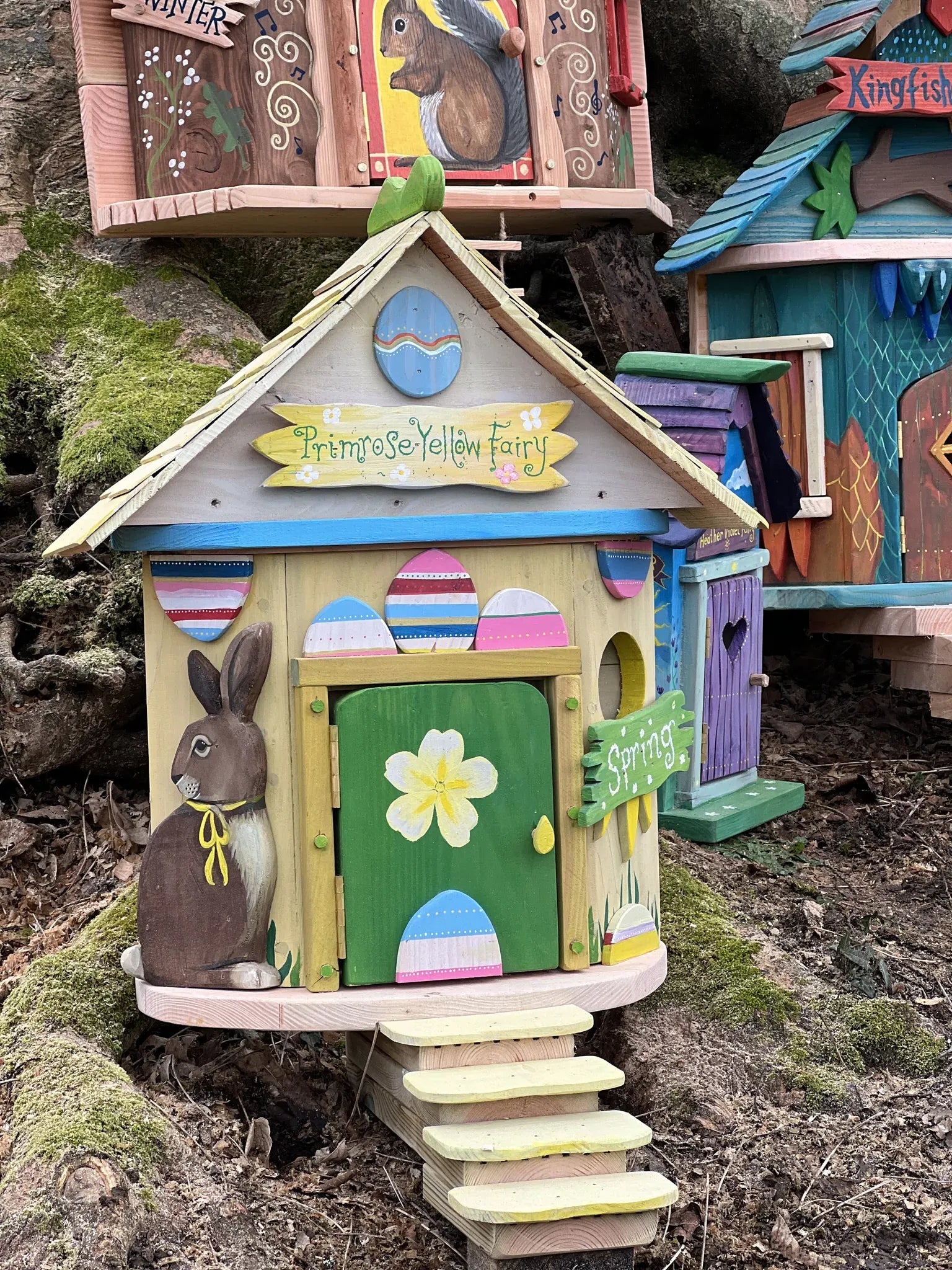 Rear angle of primrose fairy house showing hand-painted spring details and reclaimed timber construction