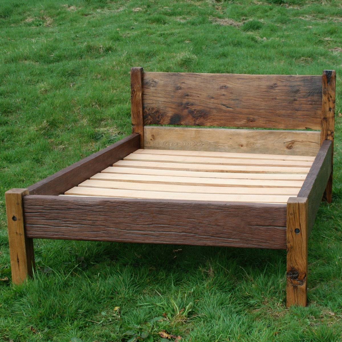 Handmade Reclaimed Oak Bed with a rustic wooden frame, crafted from eco-friendly materials in Wales. Available in single, double, king, and super king sizes.