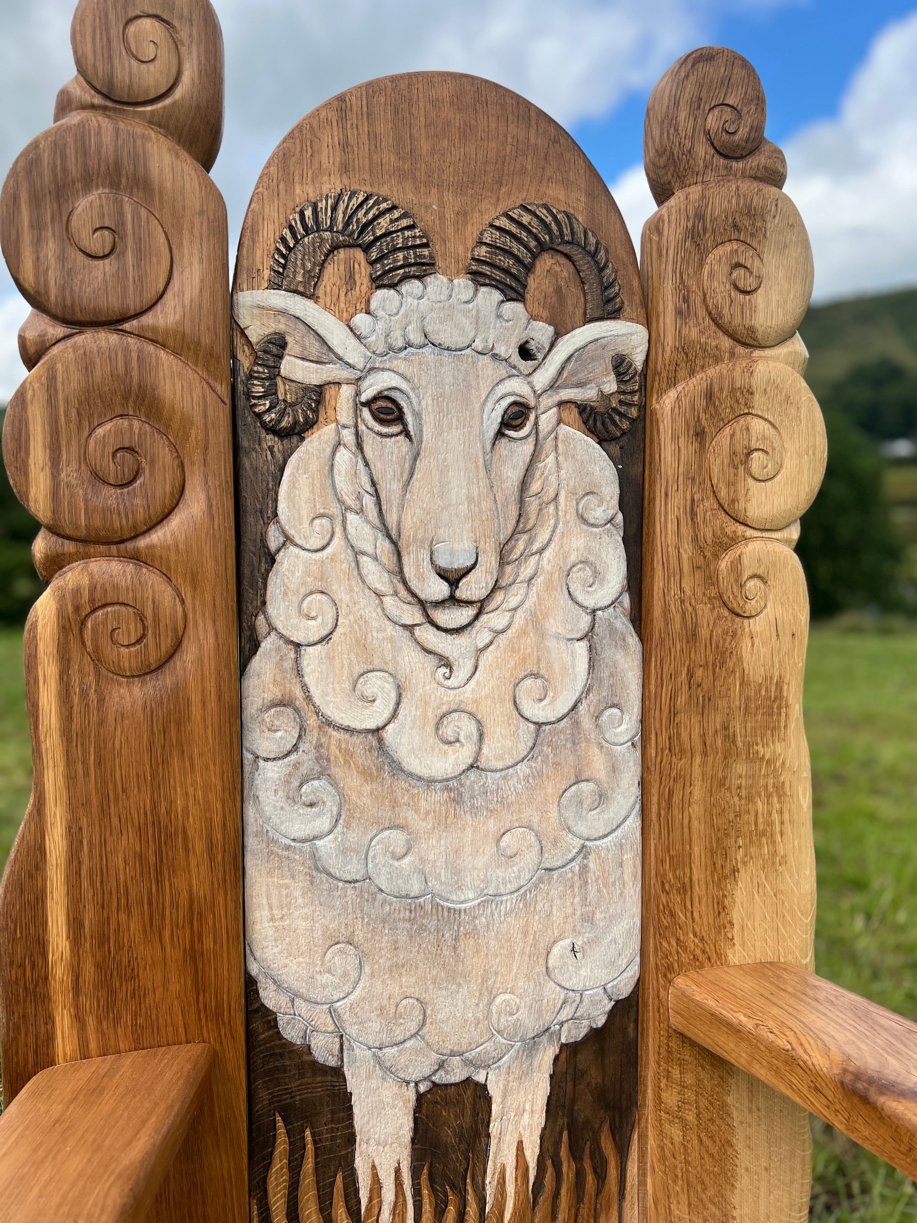 Hand carved sheep on backrest of throne for school