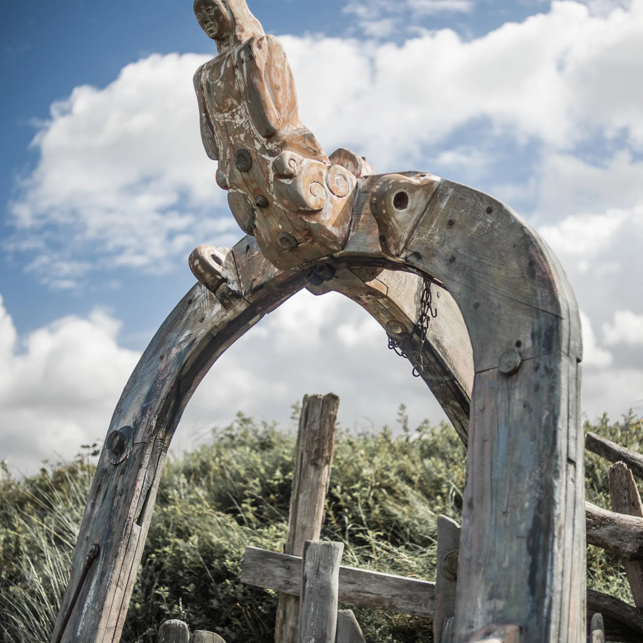 Shipwreck storytelling chair carved from solid oak | arch with carved figurehead at apex | Meirion's Trail Harlech