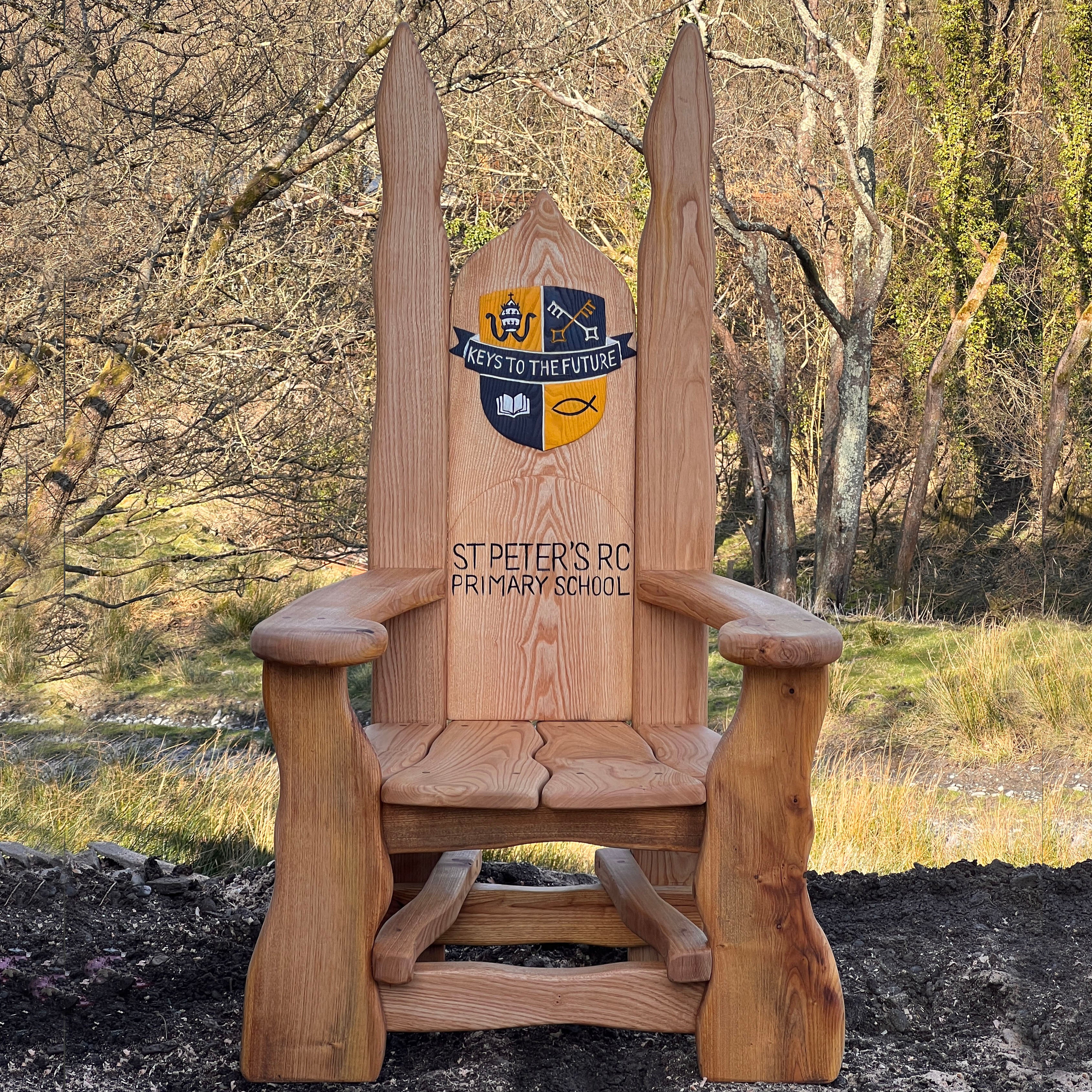 school insignia carved onto wooden chair