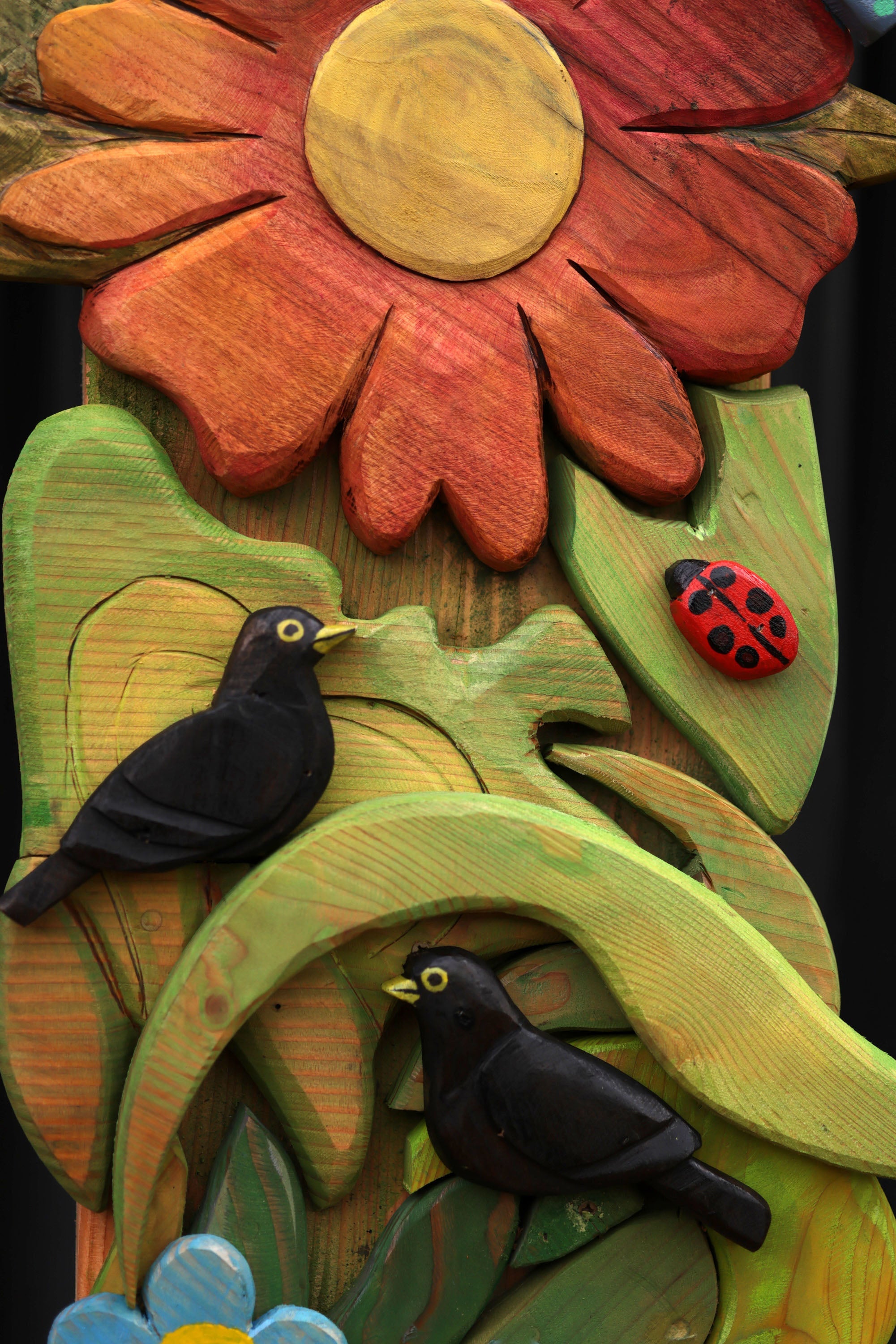 carved wooden flowers on school arch