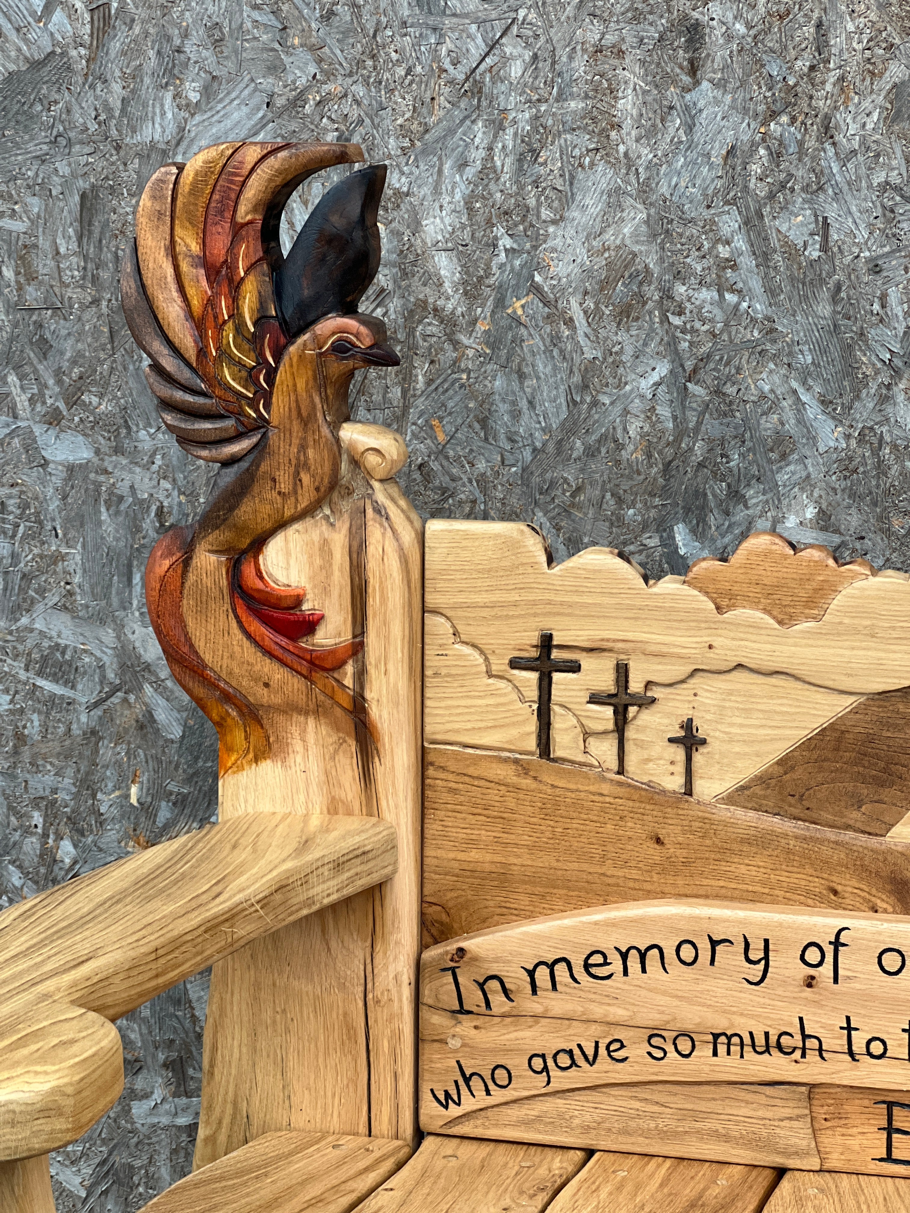 Wooden sculpture of a phoenix with engraved text