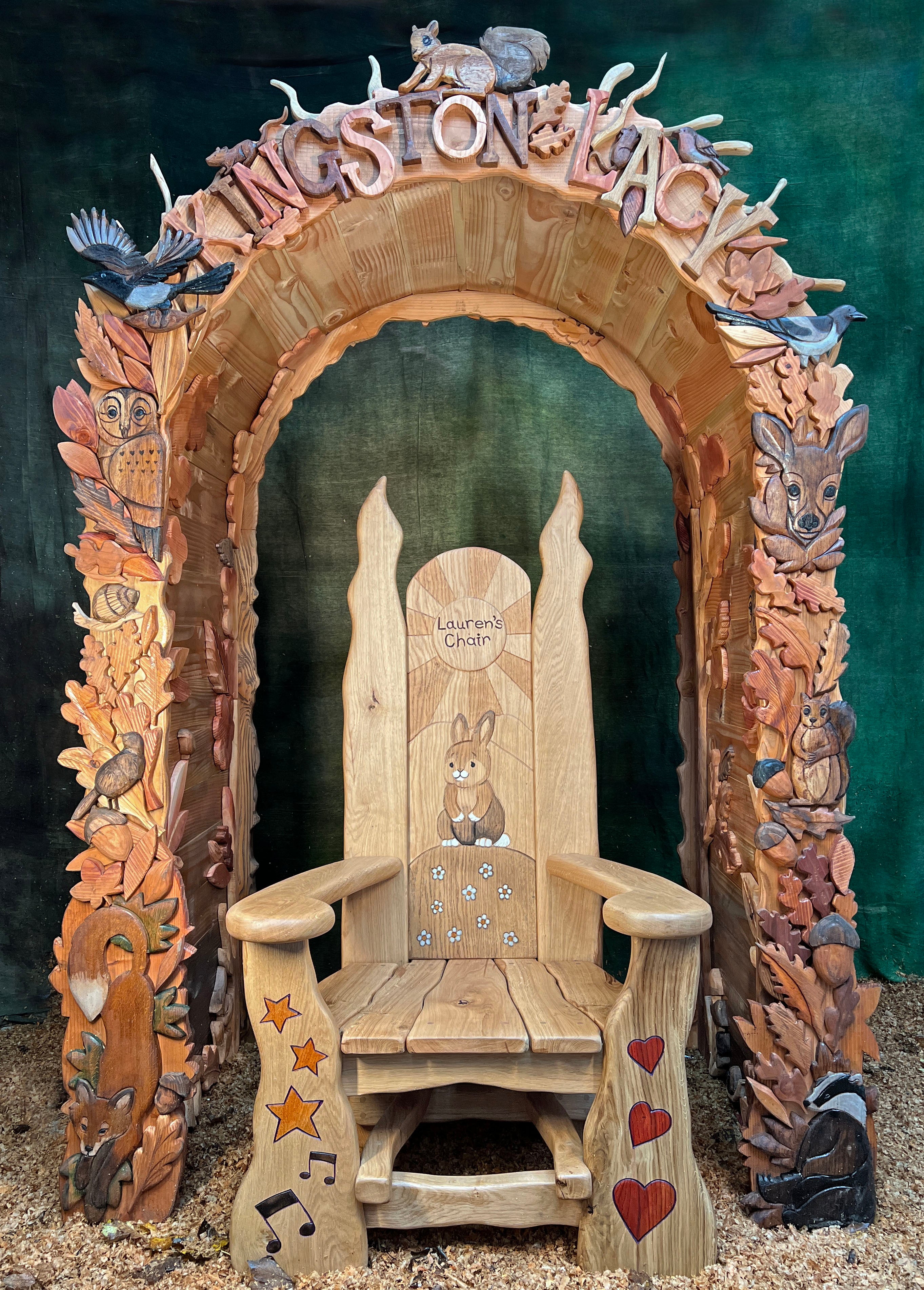 woodland carved arch displayed with children storytelling chair in centre