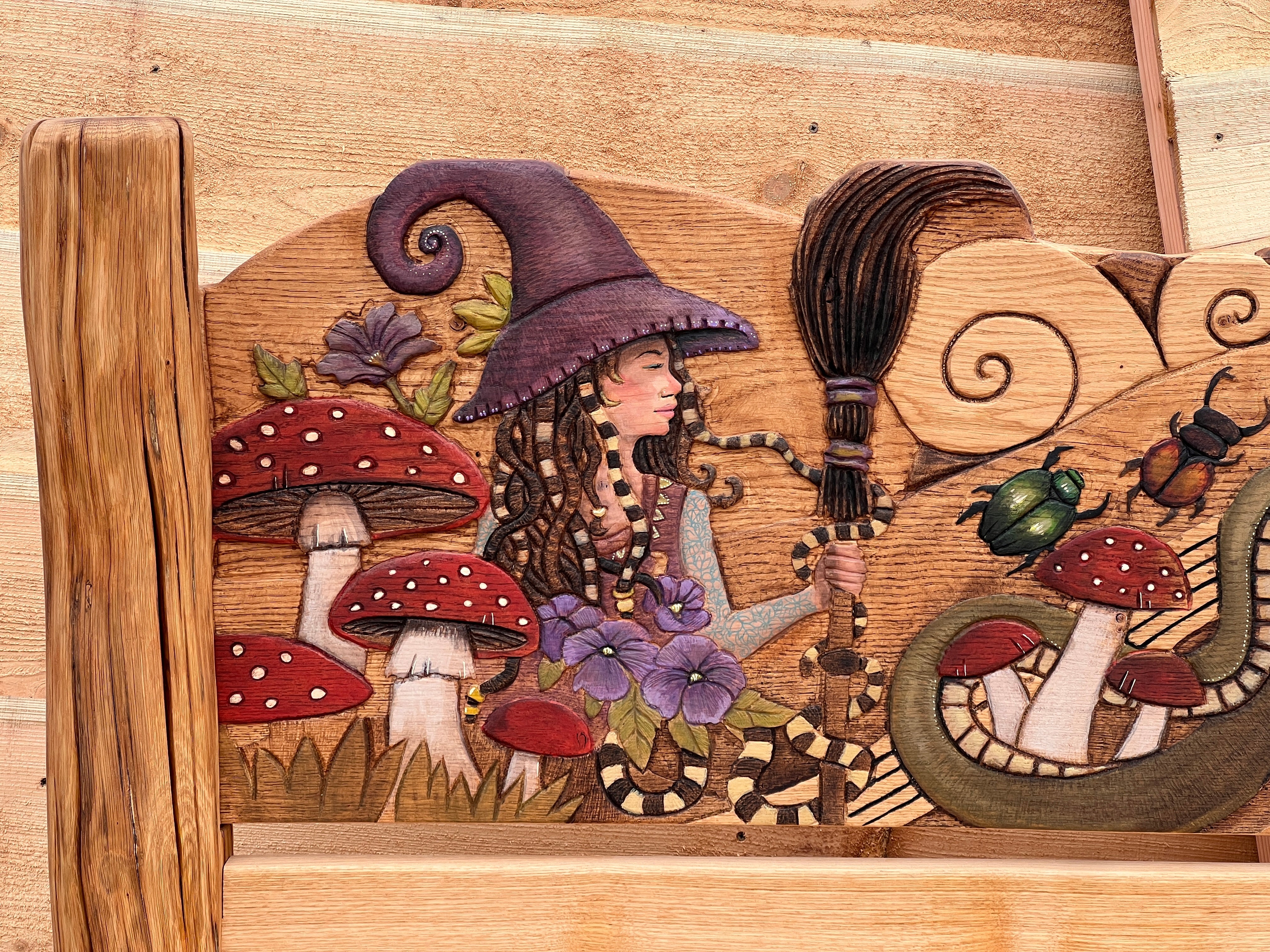 Fantasy oak bed headboard showing hand-carved witch with broomstick, snake, Buddha on lotus and red mushrooms | solid oak