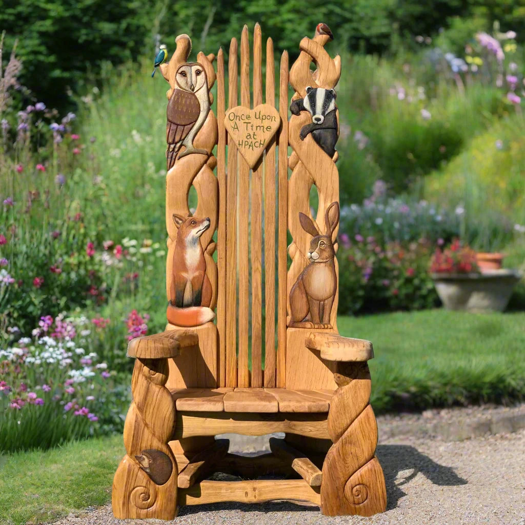 Handcrafted storytelling chair featuring intricately carved woodland animals, perfect for inspiring imagination in gardens, schools, and outdoor spaces.