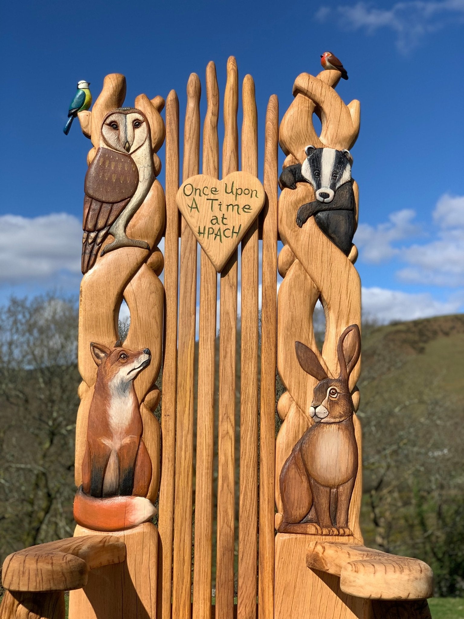 Animal kingdom storytelling chair with carved fox and owl woodland design