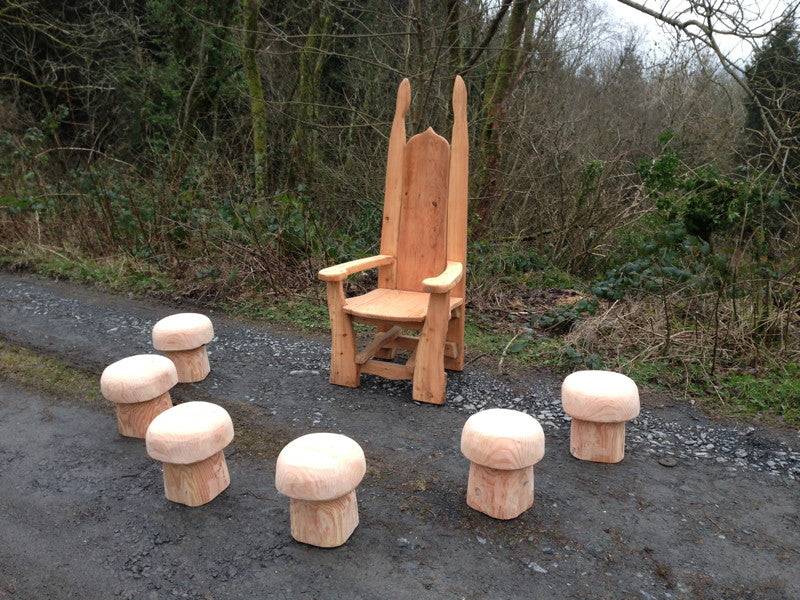 Oak mushroom stools alongside pixie woodland storytelling chair — handmade school furniture, Wales