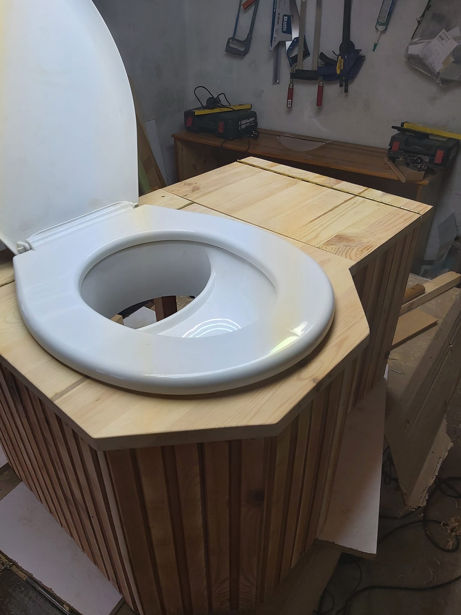 Compost toilet with urine separator in workshop setting