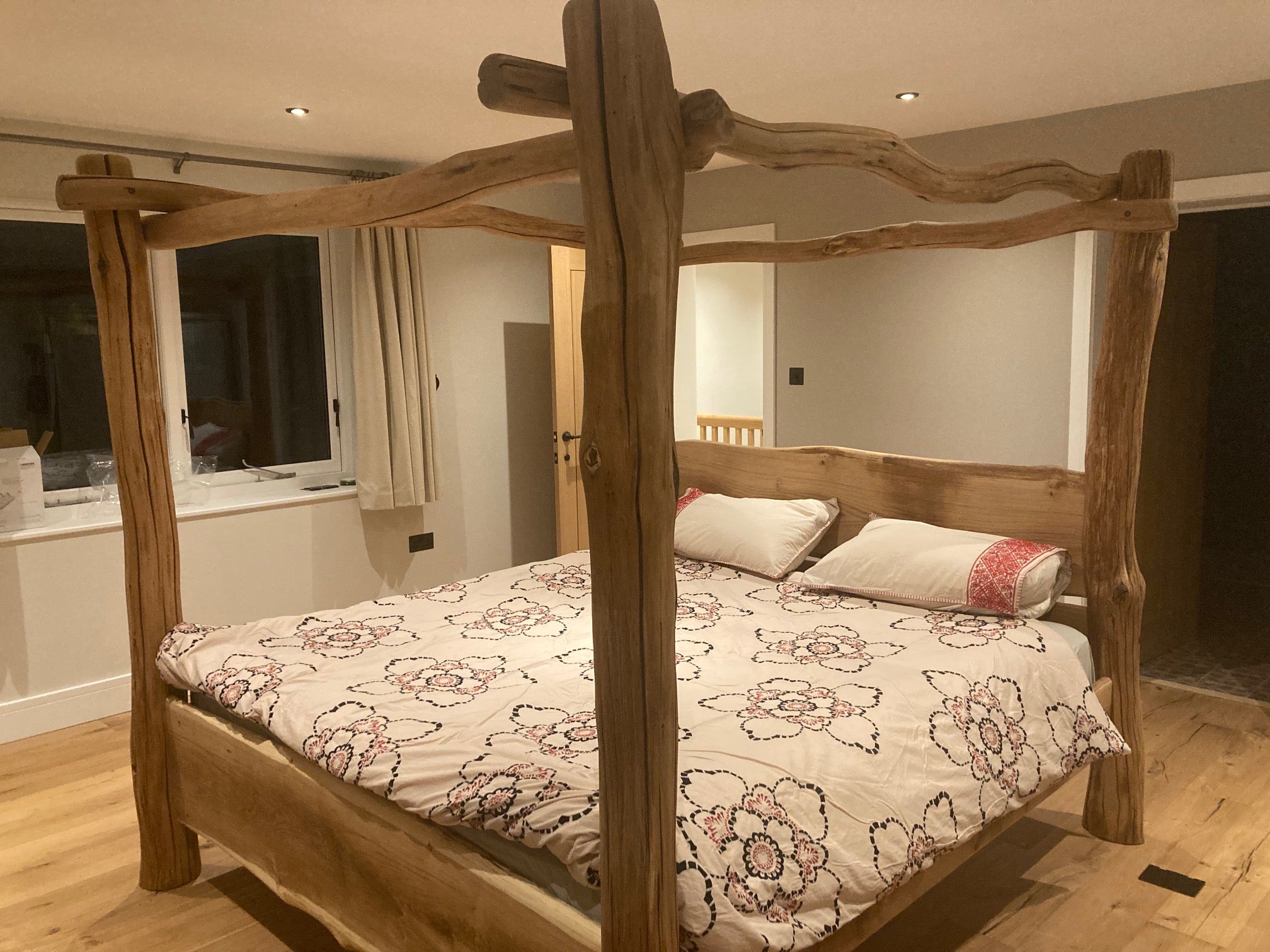 four poster bed frame made from oak in bedroom with mattress