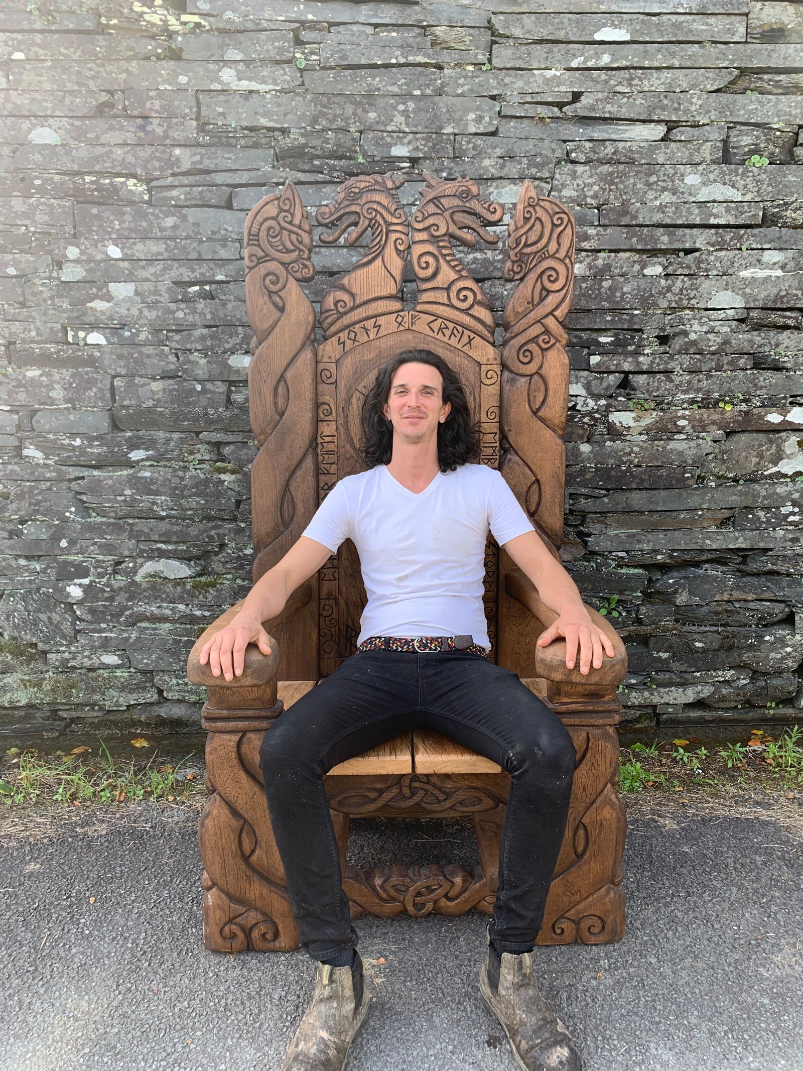 Person sitting on Viking Throne Chair