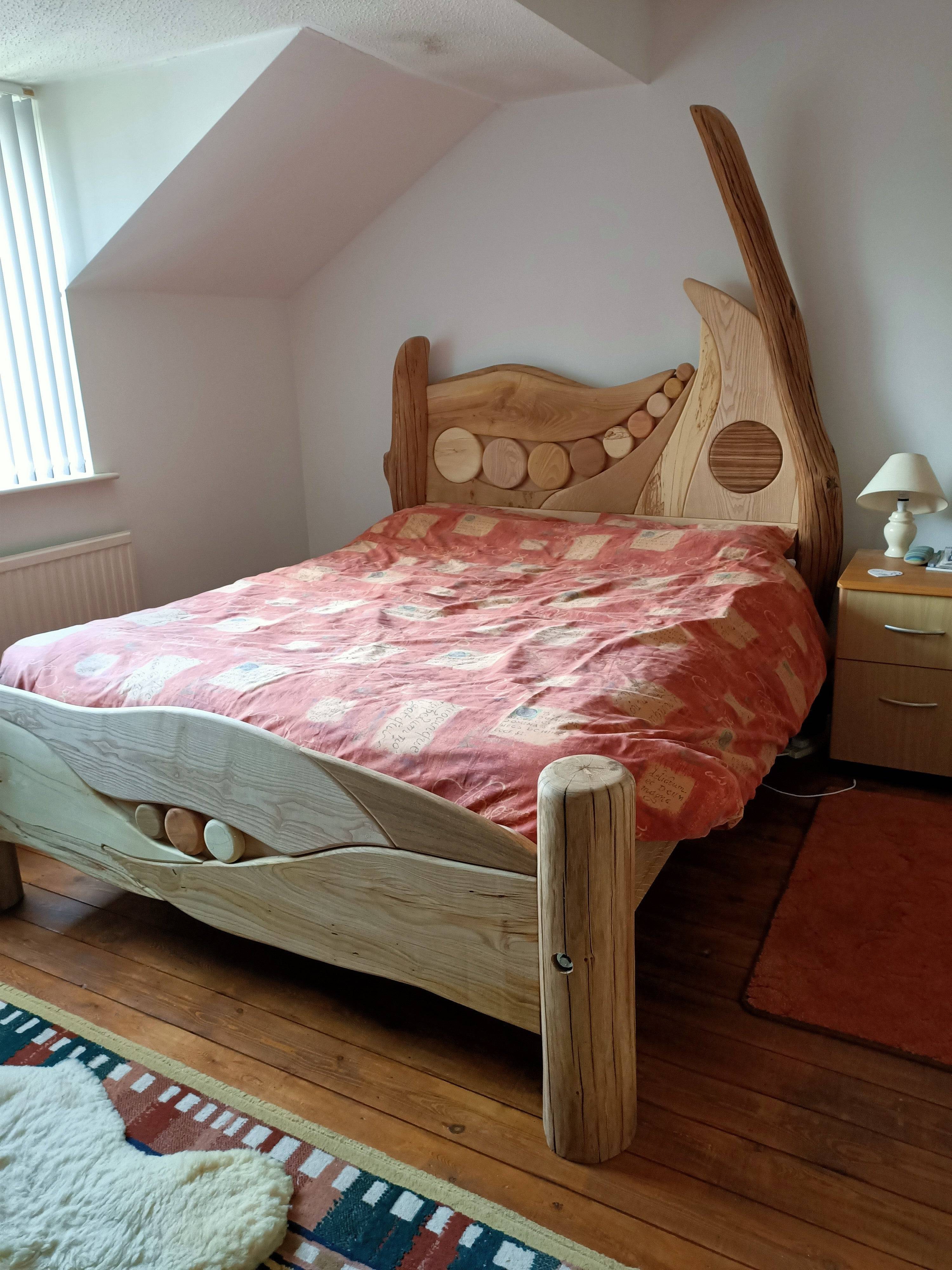 Unique wooden bed with circular wood accents