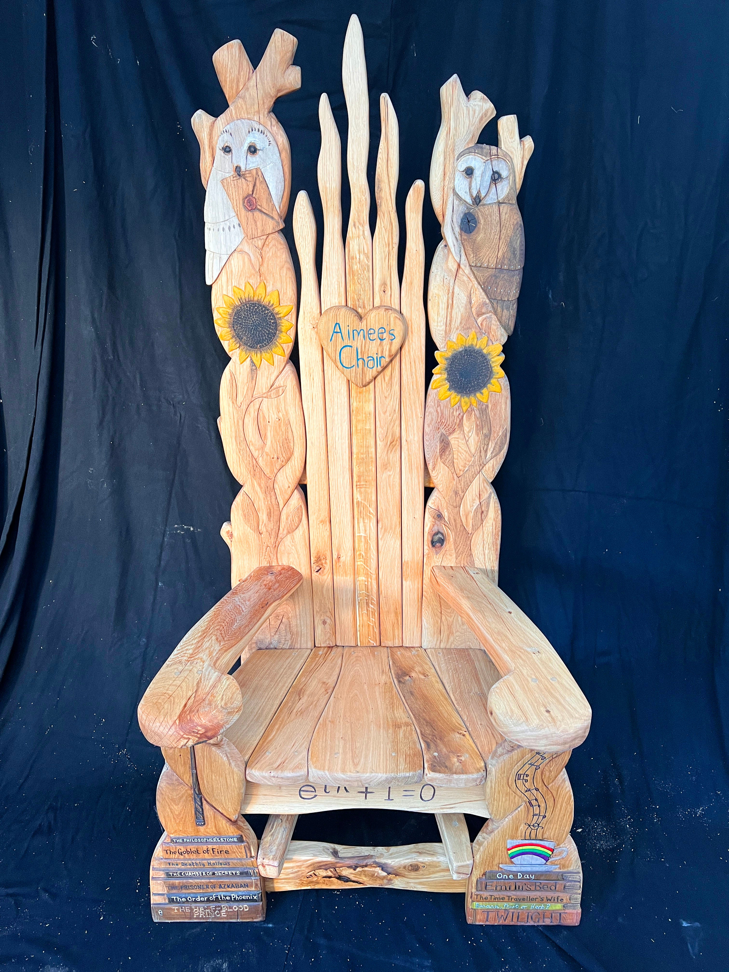 Custom wooden storytelling chair adorned with sunflowers, owls, and engraved Harry Potter titles.
