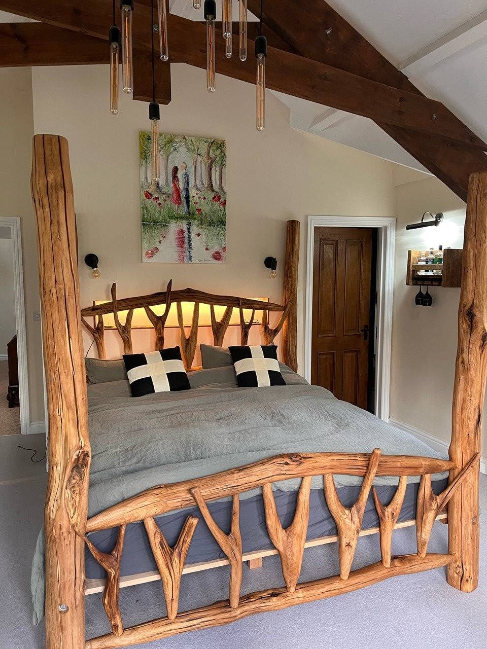 Rustic canopy bed with natural wood branches