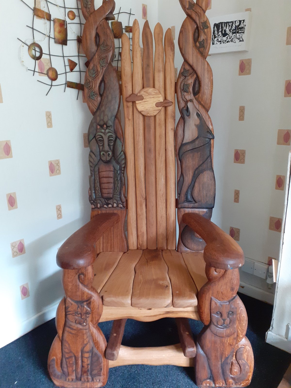 wooden chair with dragon carving on backrest with cat and wolf designs