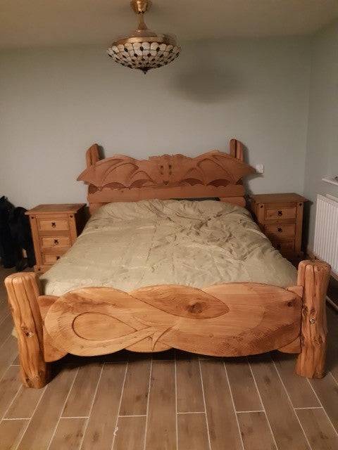 Handcrafted bed with bat motif carvings