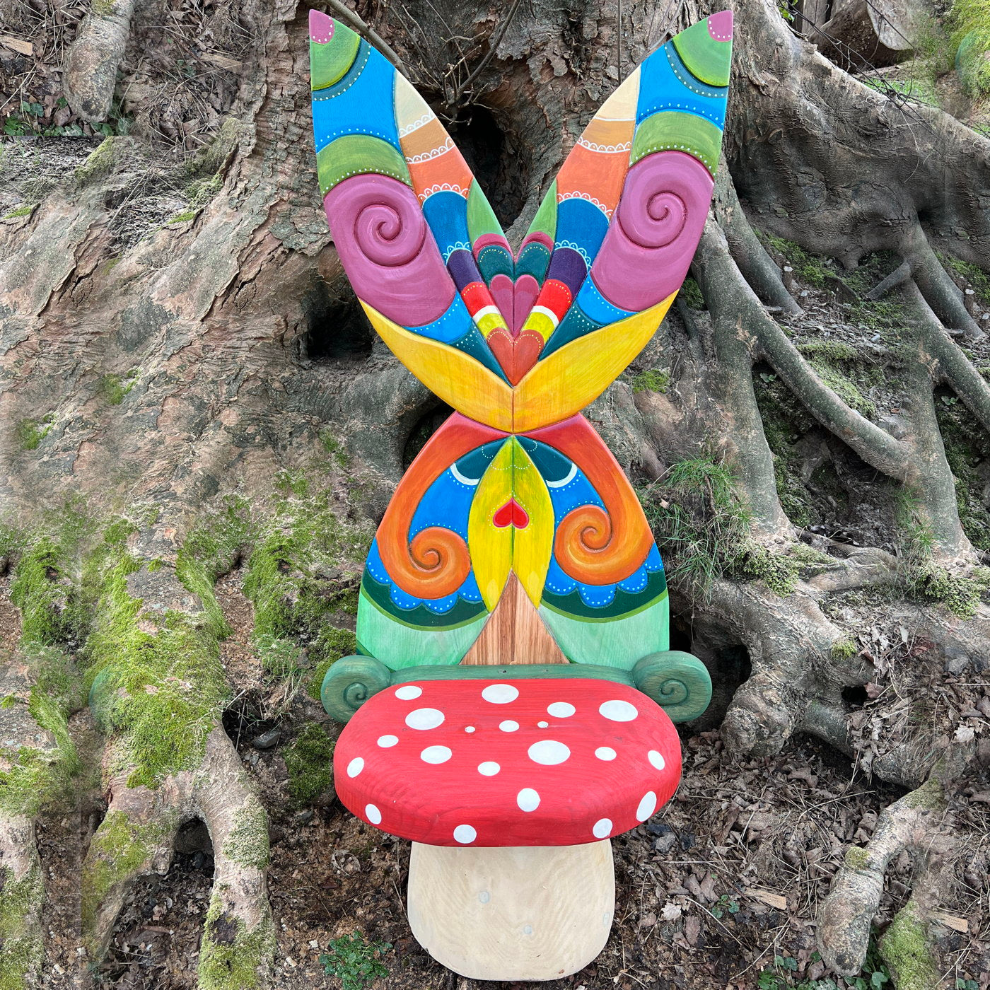 Fairy chair with colorful wings in a forest setting