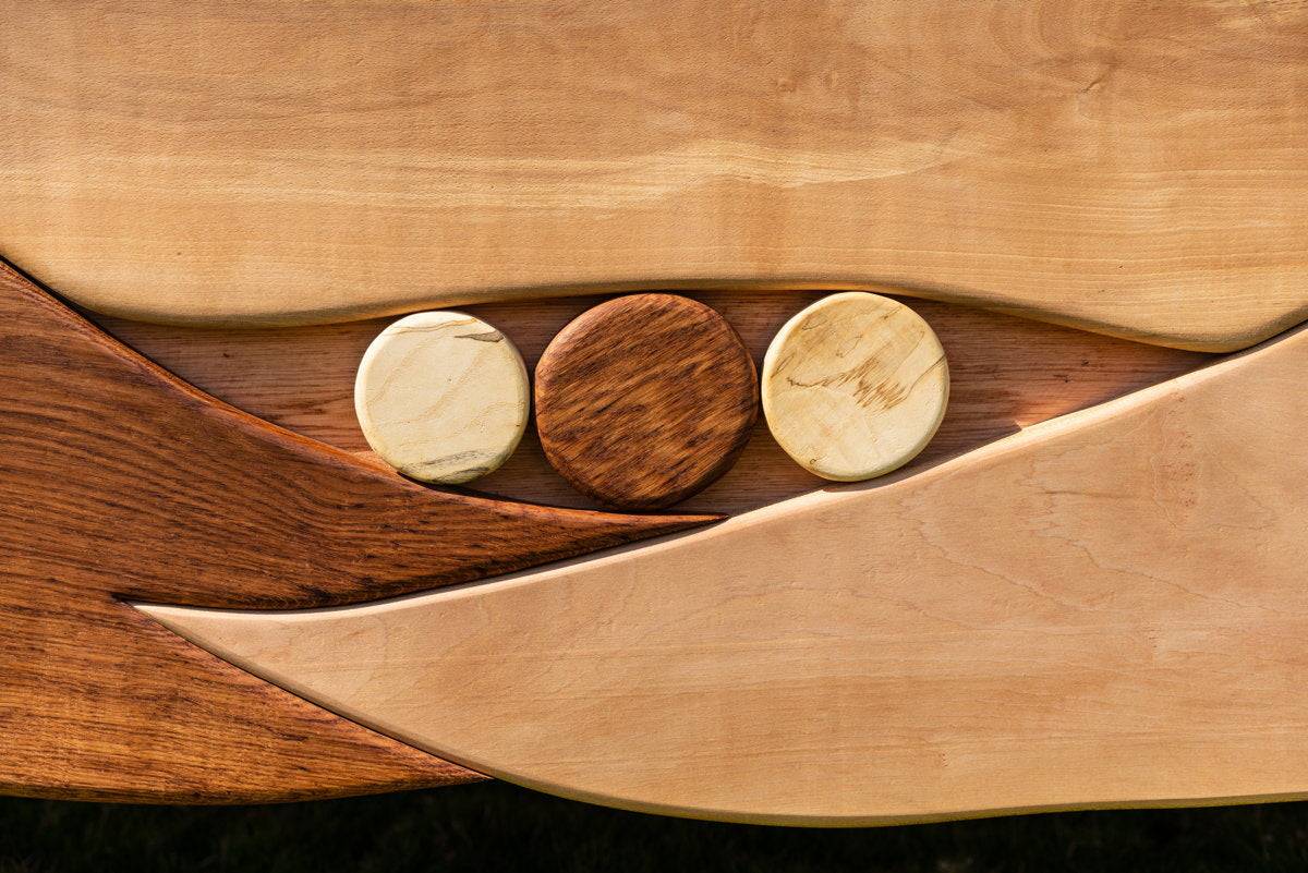 Detail of handcrafted bed frame with circular wood accents