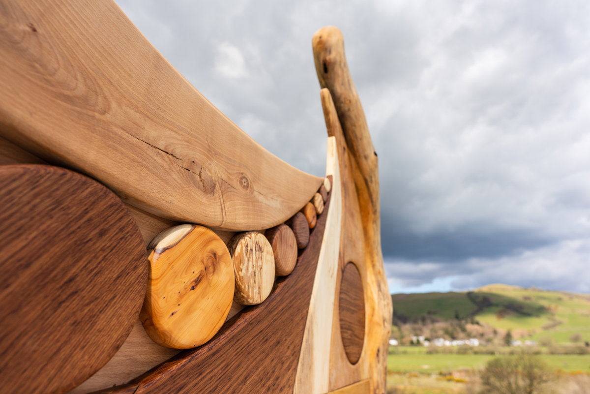 Close-up of driftwood bed frame with circular accents