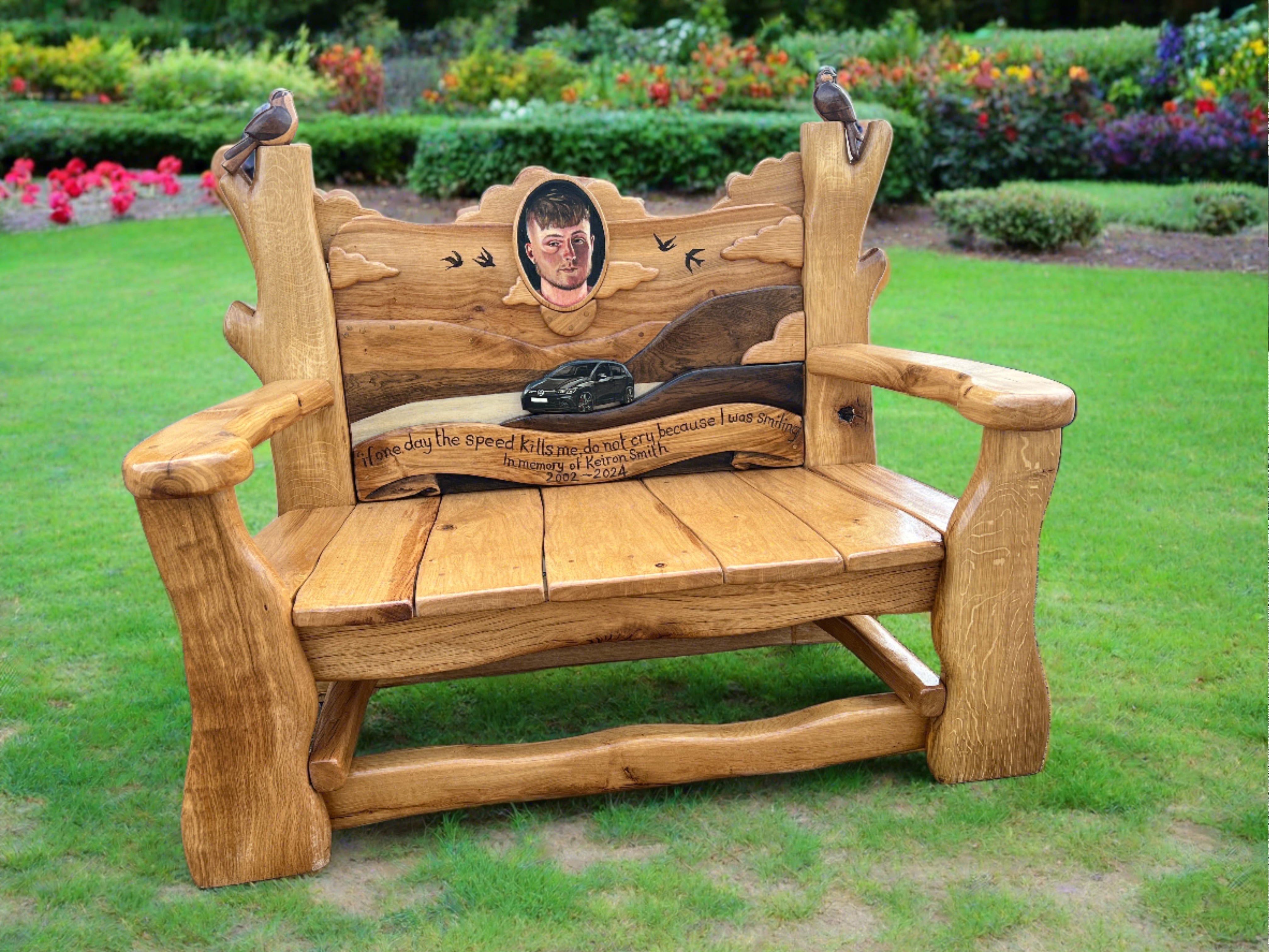 Wooden memorial bench with personalized engraving on lawn