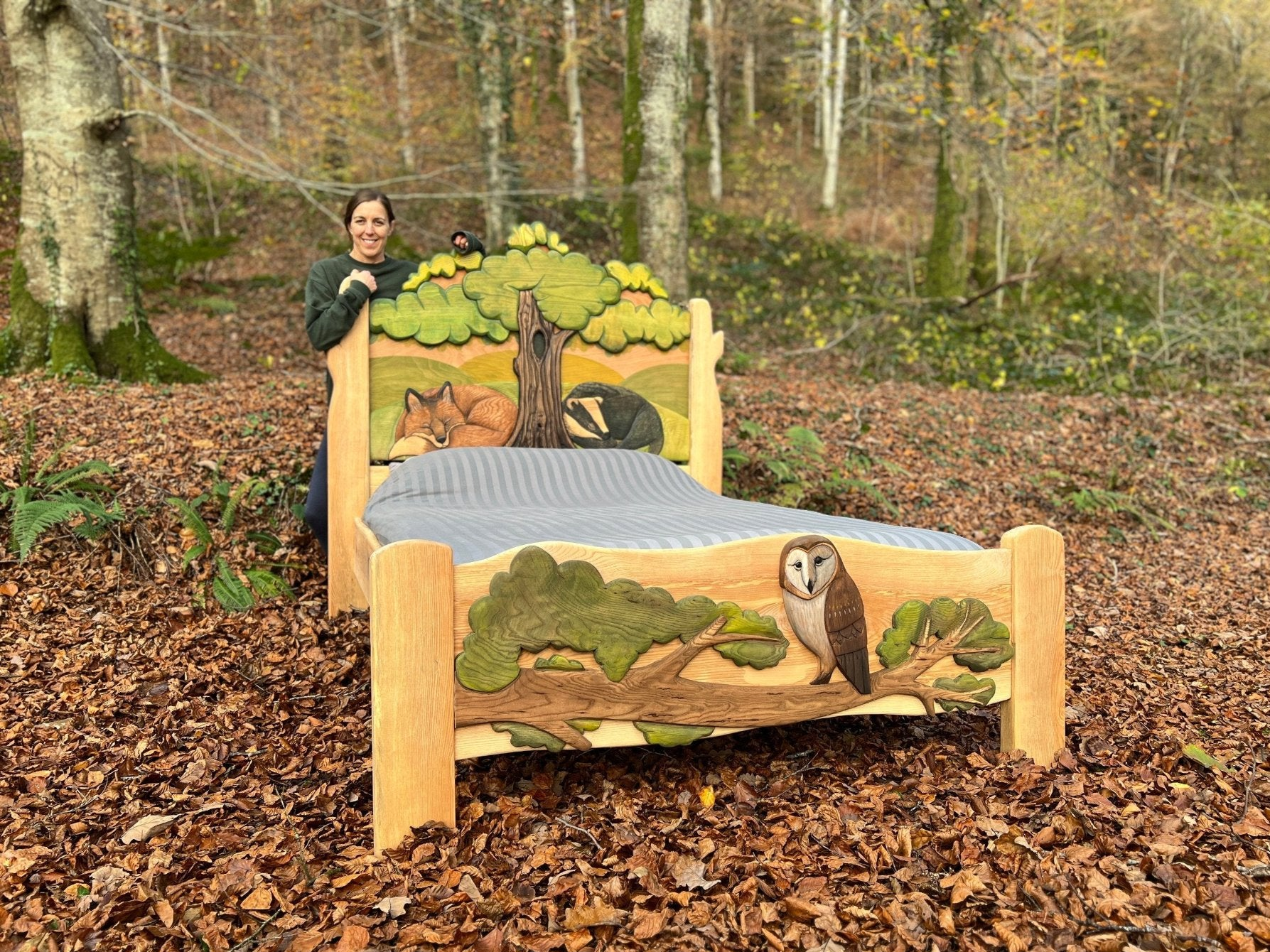 carved animals handmade wooden bed in a forest with suzanne