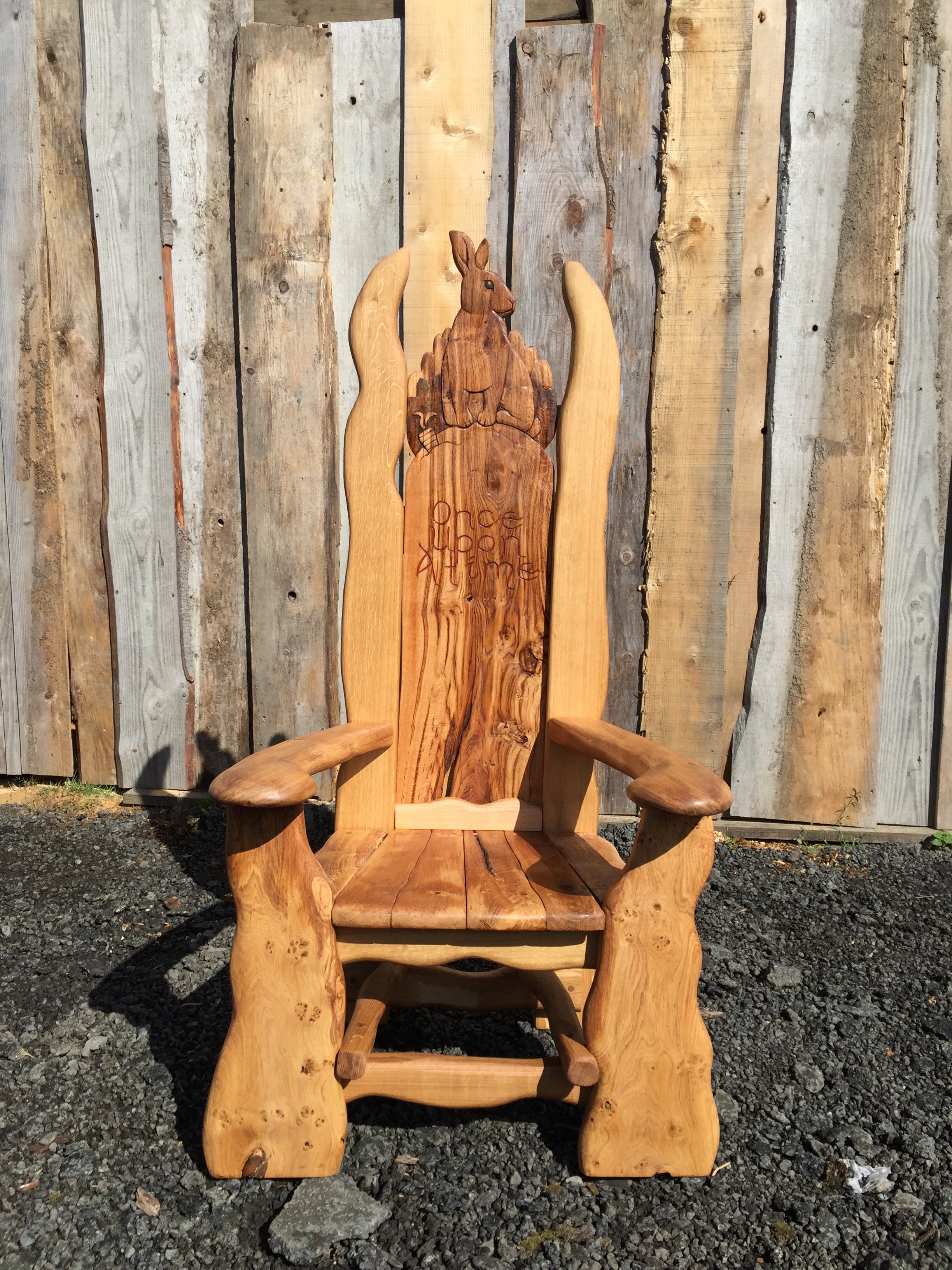 Wooden chair with rabbit carving and inscription.