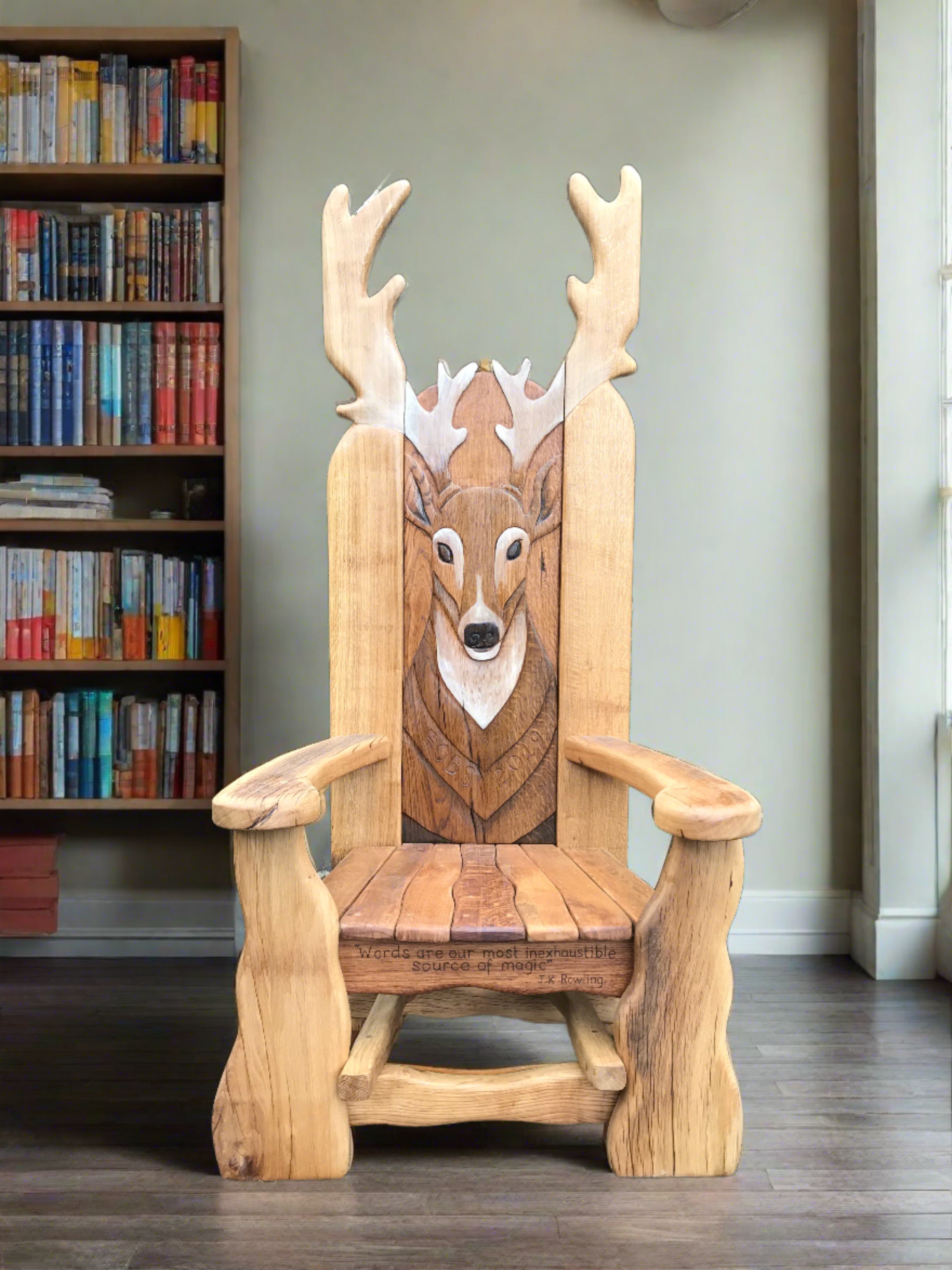 Wooden chair with deer carving in a library.