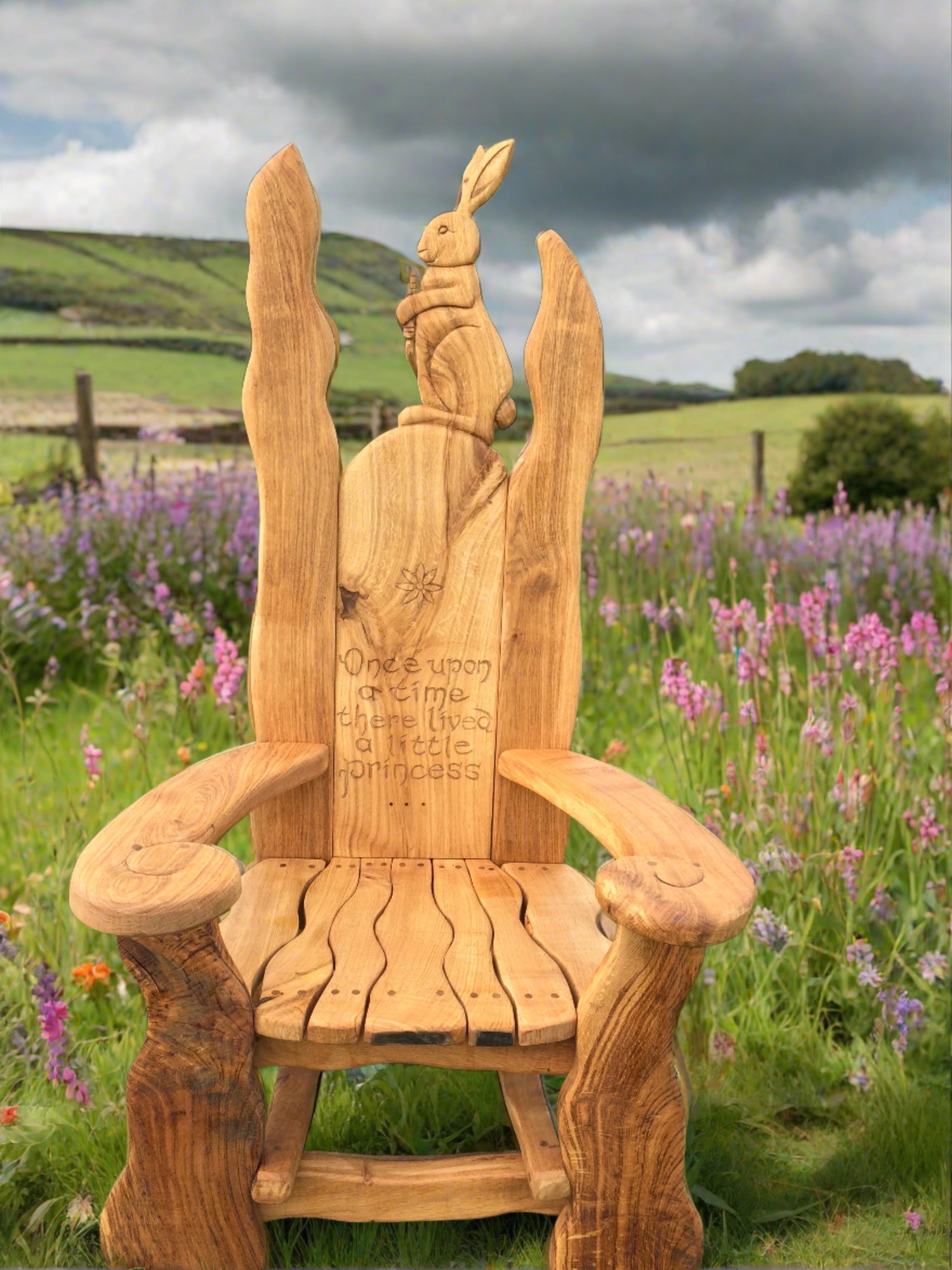 Wooden chair with rabbit carving in a floral field.