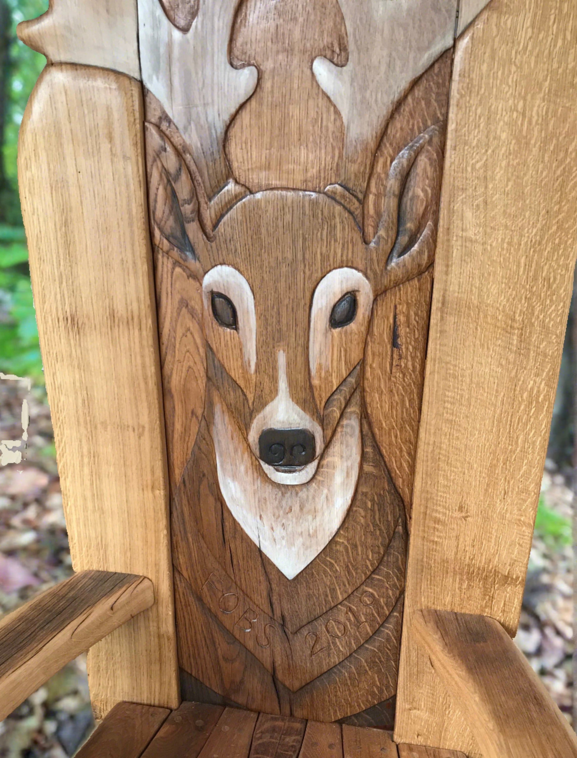 Gros plan d'une sculpture de cerf sur une chaise en bois.