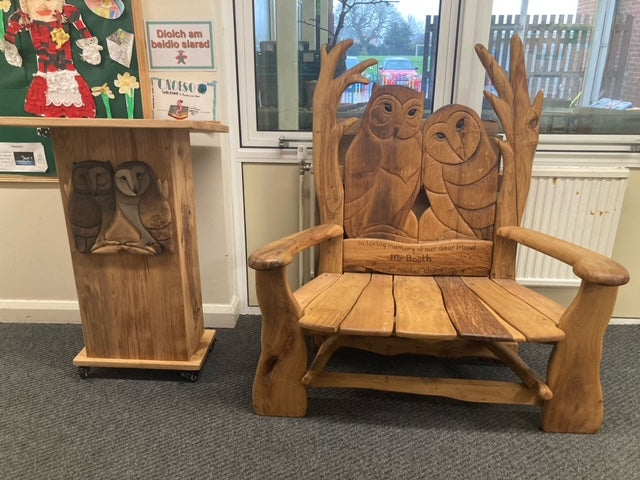 Owl-themed wooden bench in school setting