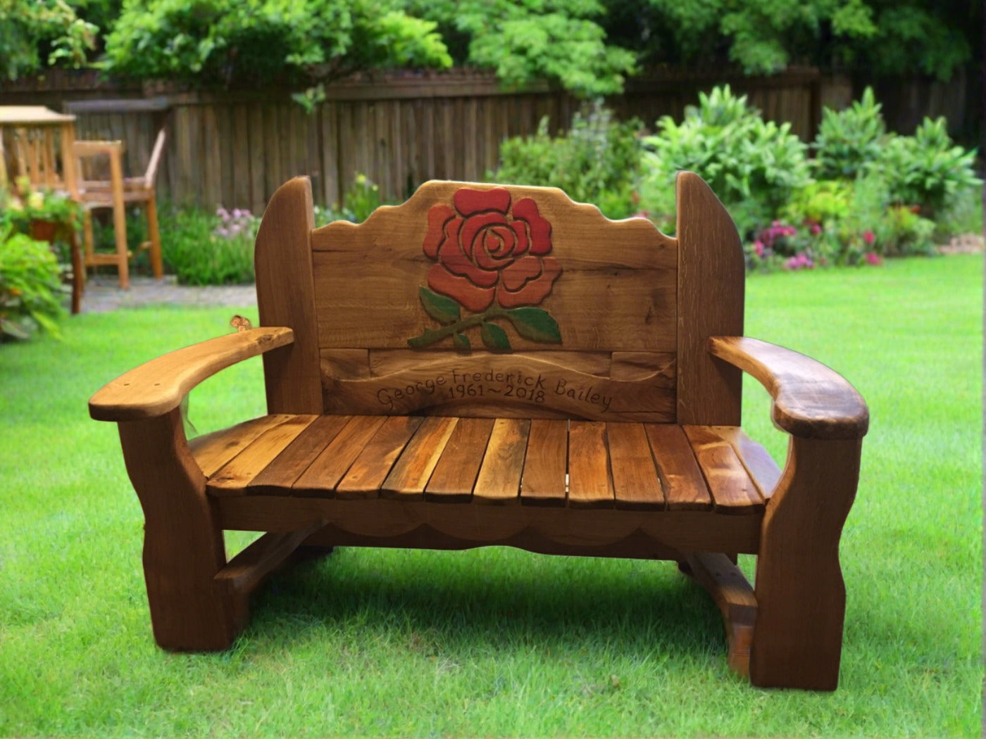 Garden bench with rose carving and commemorative text.