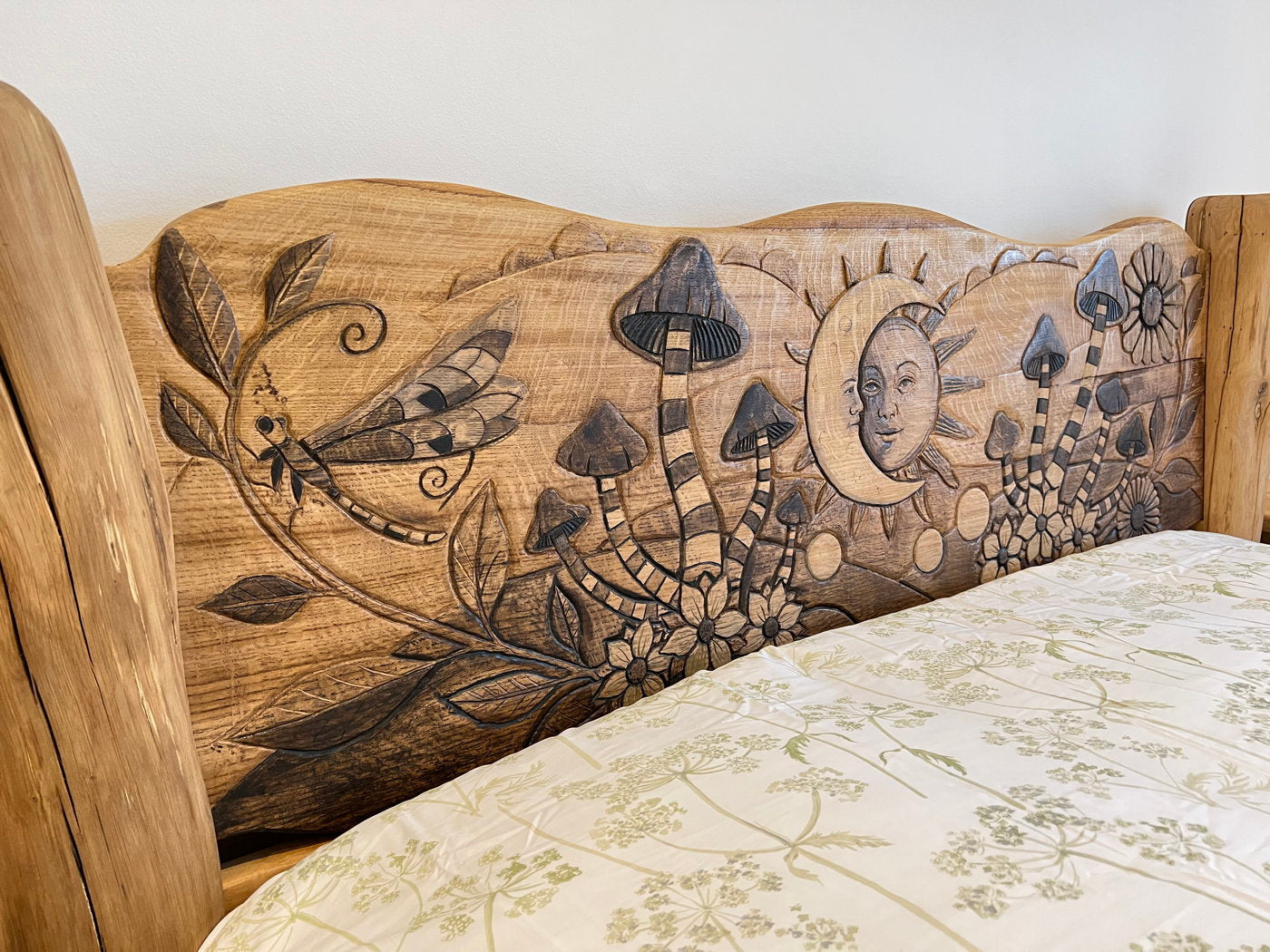 Close-up of headboard carvings on oak bed